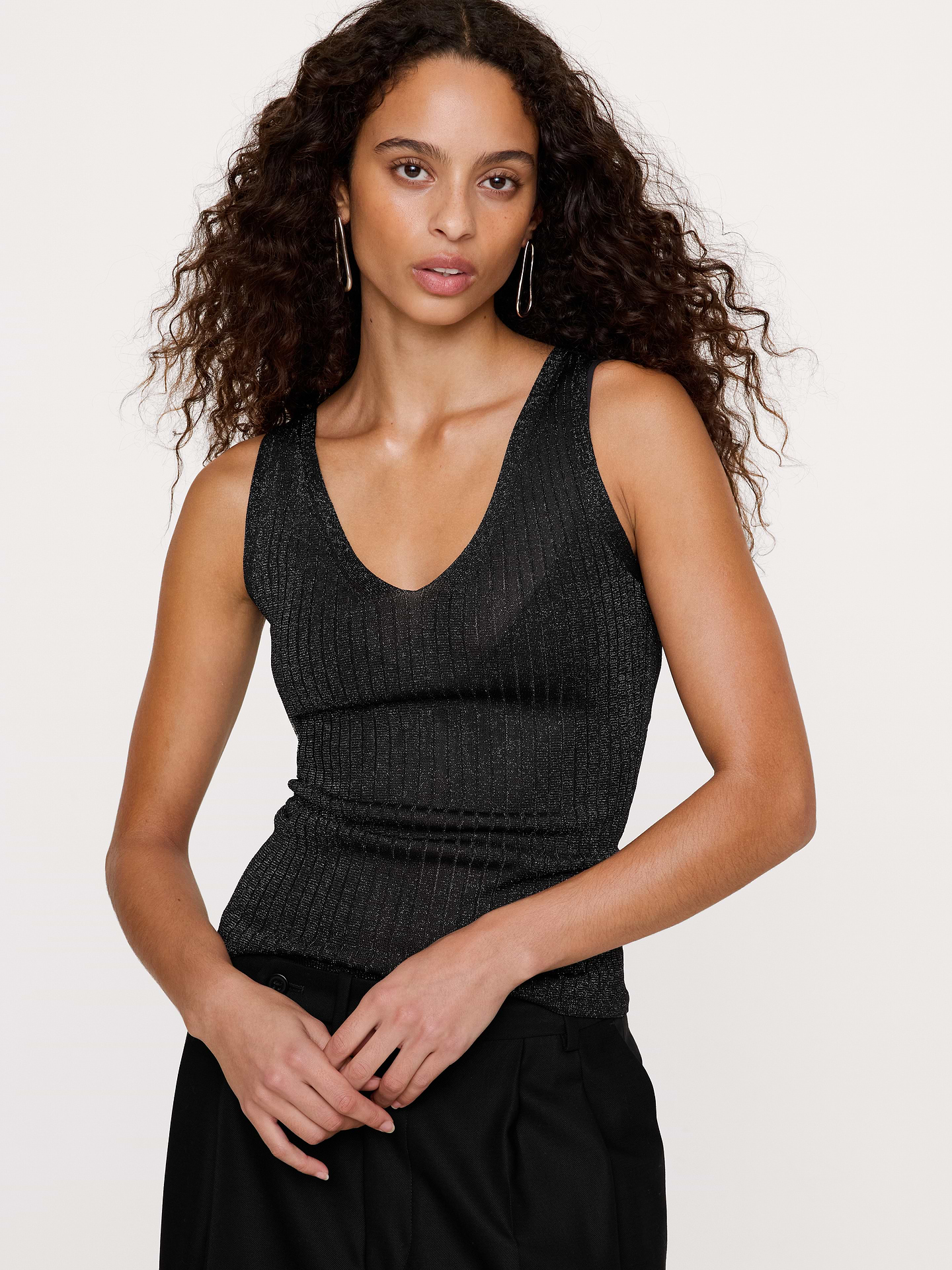 Image 1 of 8, This sleek sweater tank is knitted using a subtly metallic yarn, enhanced by artfully arranged rib-knit stitches to enhance its figure-hugging silhouette., Fitted: Slim. Sits close to the body., Fabric from Italy's Lanificio dell'Olivo., V-neck., Straight hem., Product #1181559