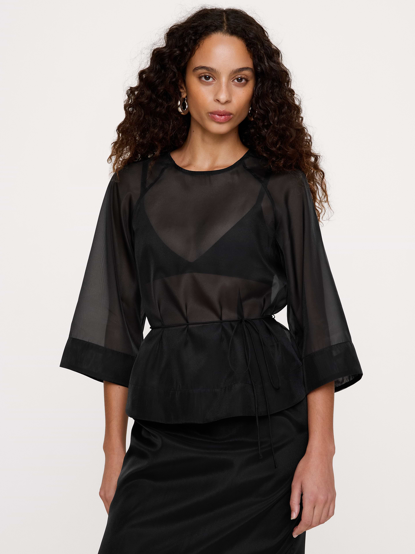 Image 1 of 8, Our flowy peplum top is cut from lightweight and breathable organza with just enough structure to hold its shape beautifully. Sheer., Fit & Flare: Fitted through the chest, shoulders, and waist with a flare skirt., Crew neck with button-keyhole at back., Unlined., Product #1181560