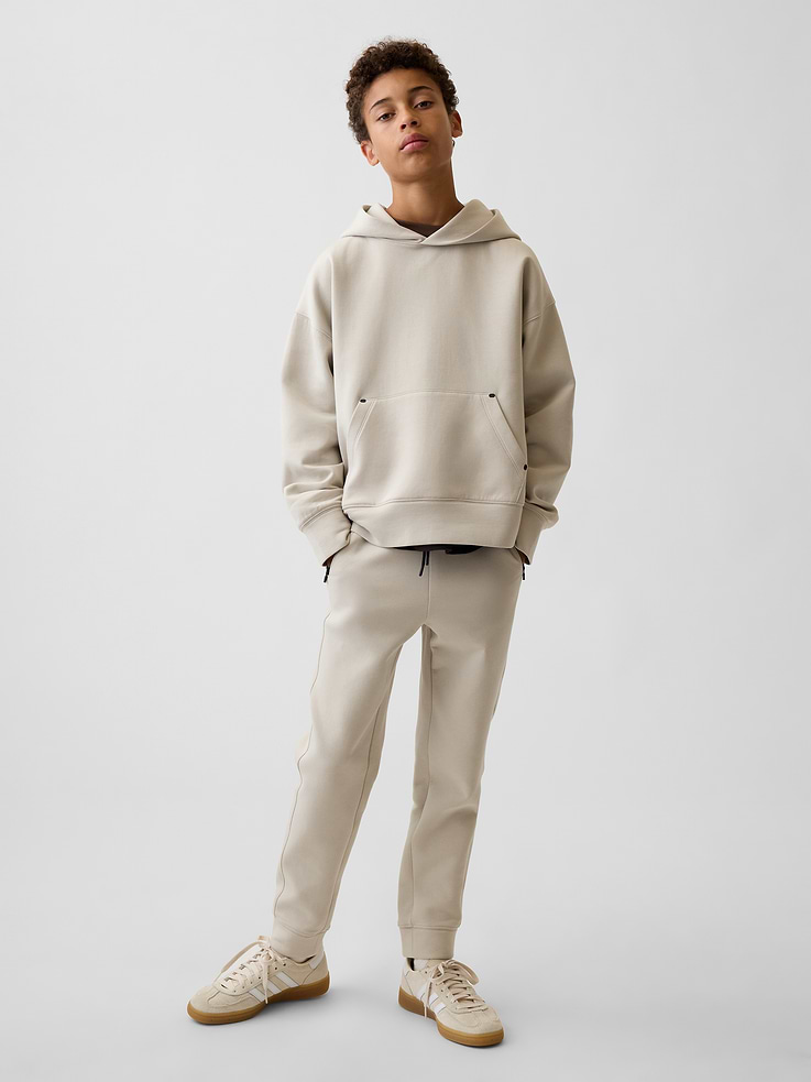 Image 1 of 5, Breathable, stretch active knit joggers. In a slim fit., Elasticized waist with drawcords., Side on-seam zip pockets., Banded cuffs., This product was made in a factory that invests in gender equity and women’s empowerment through RISE. Learn more at gapinc.com/equity ., Product #1184265