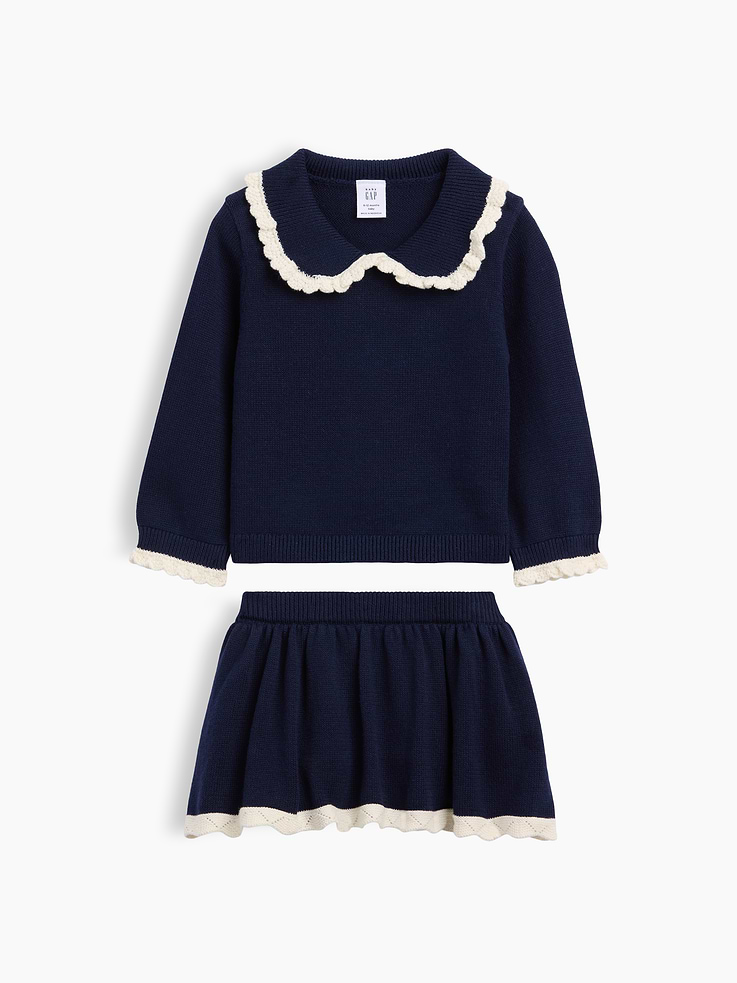 Image 1 of 2, Soft knit cotton sweater and sweater skort outfit set., Peter Pan collar with ruffle trim., Long sleeves with ruffle trim., Ribbed hem., Elasticized rib waist at skirt., Scalloped edge at bottom hem., Attached inner shorts., This product was made in a factory that invests in gender equity and women’s empowerment through RISE. Learn more at gapinc.com/equity ., Product #1185451