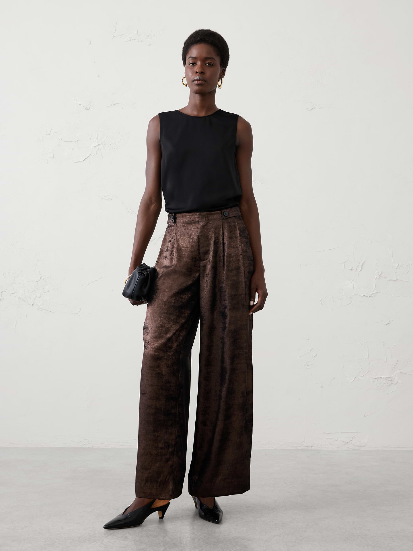 Image 1 of 5, Make a statement from day to night in this metallic trouser. Crafted from a lustrous metallic fabrication with a fluid drape, this elevated silhouette combines modern shine with timeless tailoring., Classic fit. High rise. Wide leg. Full length., Hook-and-bar closure with zip fly., Waistband tab detailing., Front pleats., Off-seam front pockets., Back welt pockets., Made exclusively for Banana Republic Factory., Product #1183280