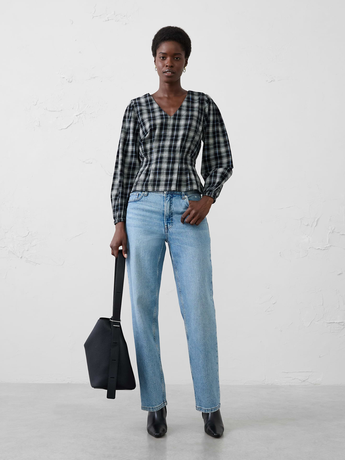 Image 1 of 4, Feminine details meet cozy comfort in this flannel blouse, designed to elevate holiday casual dressing. Crafted from a soft plaid flannel, this style features a flattering V-neckline, voluminous sleeves, and delicate pleated detailing that creates beautiful shape and texture through the bodice., V-neckline. Voluminous long sleeves with elasticized cuffs., Delicate pleated detailing., Back smocking at waist., Peplum hem., Made exclusively for Banana Republic Factory., Product #1185901