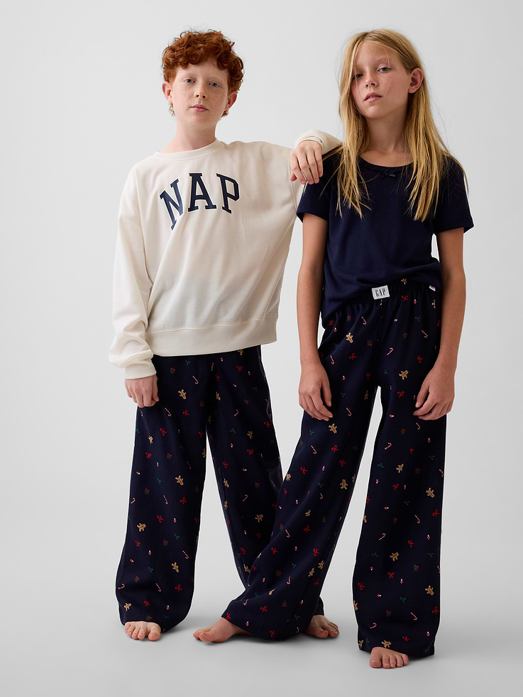 Image 1 of 5, Soft, brushed flannel pajama pants. In a loose fit., Elasticized waist with Gap label at front., Allover print., Made with 100% recycled polyester. Compared to virgin materials, using recycled materials helps reduce resource use and waste., Shop matching PJs for all., This product was made in a factory that invests in gender equity and women’s empowerment through RISE. Learn more at gapinc.com/equity ., Product #915781