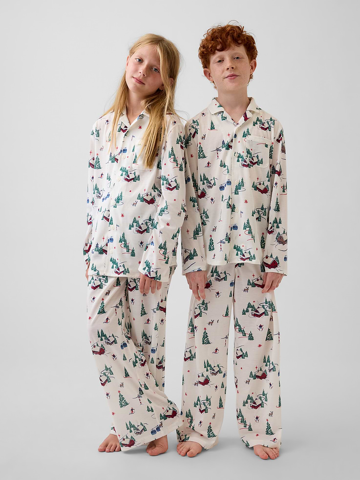 Image 1 of 5, Soft knit jersey pajama shirt and pants PJ set. In a relaxed fit., Notch collar., Long sleeves with drop shoulders., Button front., Chest patch pocket., Elasticized waist at pajama pants., Allover print., Made with 100% recycled polyester. Compared to virgin materials, using recycled materials helps reduce resource use and waste., Shop matching PJs for all., This product was made in a factory that invests in gender equity and women’s empowerment through RISE. Learn more at gapinc.com/equity ., Product #915776