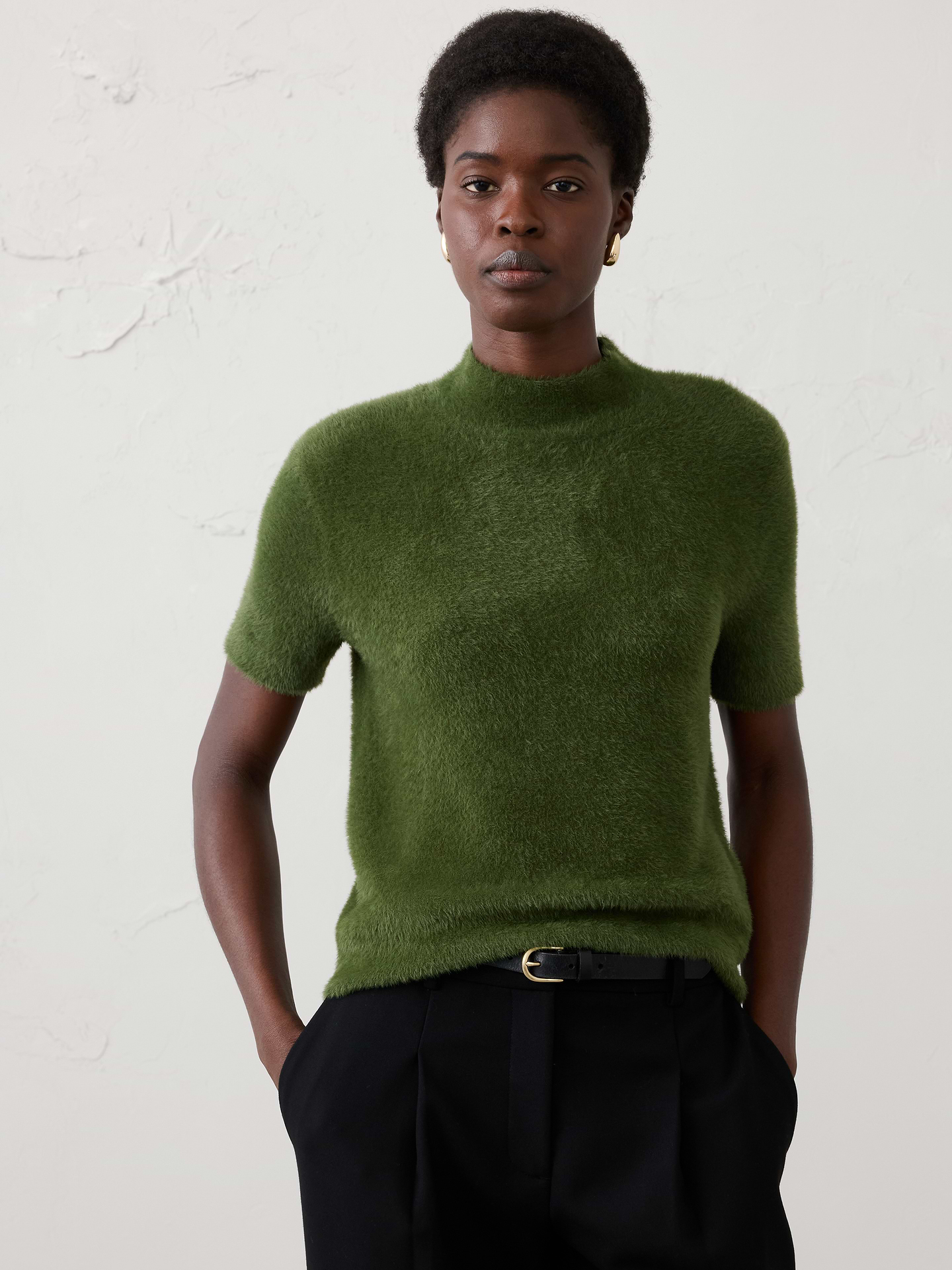 Image 1 of 4, Crafted from our signature eyelash yarn, this mockneck sweater delivers a plush, luxurious feel with rich texture and cozy warmth. The elevated mockneck silhouette adds a refined touch, while the soft, fuzzy finish makes it a standout piece for cooler weather., Mock neck. Short sleeves., Ribbed neck, arm cuffs and hem., Care suggestion: Use a low‑heat iron; steam as needed., Made exclusively for Banana Republic Factory., Product #1177067