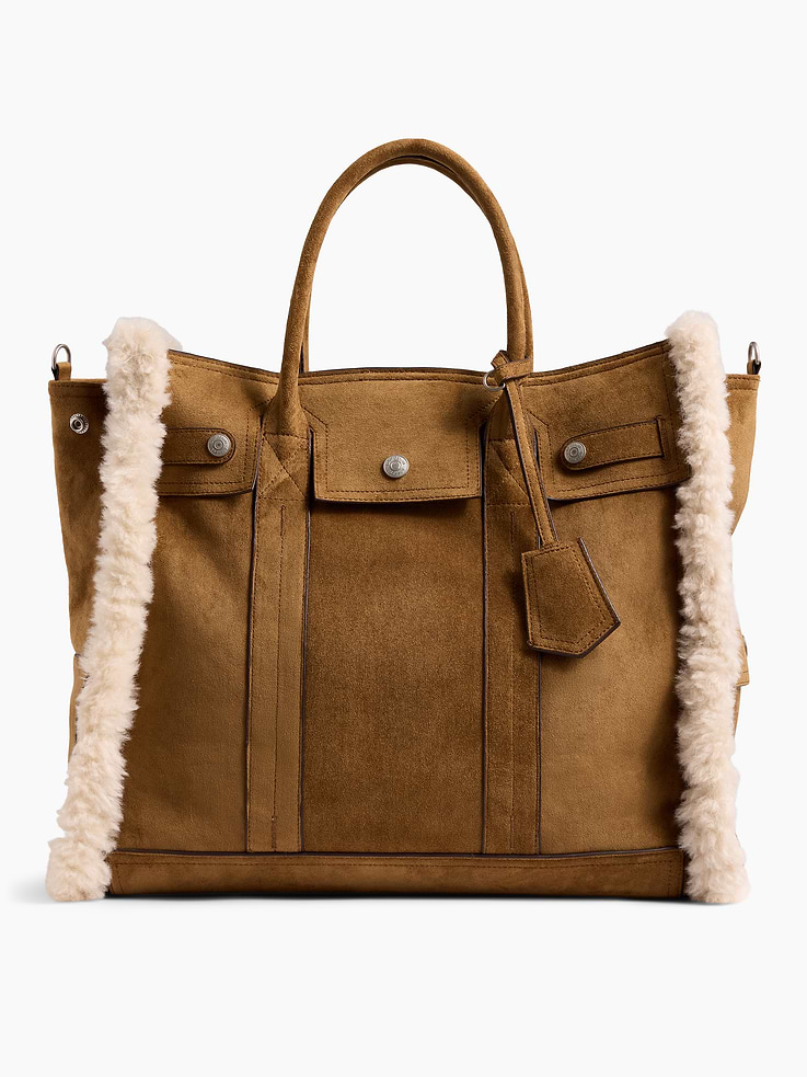 Image 1 of 7, Soft vegan suede tote bag with sherpa detailing., Worn at the elbow, over the shoulder, or handheld., Double handles and removable shoulder strap., Bridge snap closure at top., Button-snap pocket at front., Two outer side slip pockets., Key-holder tag at handle., Two interior slip pockets., Laptop friendly: up to 15"., Product #1189085