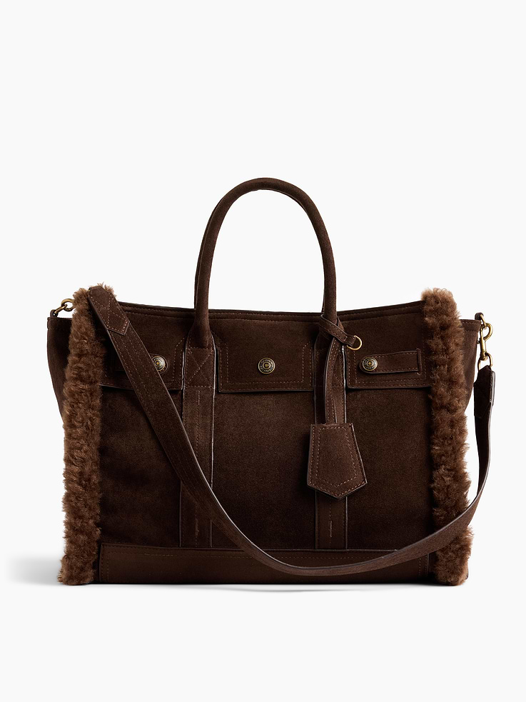 Image 1 of 7, Soft vegan suede tote bag with a cozy sherpa lining., Worn at the elbow, over the shoulder, or handheld., Double handles and removable shoulder strap., Bridge snap closure at top., Button-snap pocket at front., Two outer side slip pockets., Key-holder tag at handle., Two interior slip pockets., Laptop friendly: up to 13"., Note: The dye used in the crafting of this product is prone to crocking, or color transfer. Please avoid contact with light-colored fabric or upholstery., Product #1189400