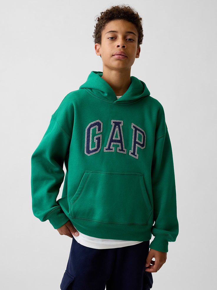 Image 1 of 5, Our softer than soft sweats. Brushed on the inside. Smooth on the outside. Made so that no two are alike., Soft cotton-blend fleece pullover hoodie. In a relaxed fit., Hooded neckline., Long sleeves with drop shoulders., Gap arch logo at front., Kanga pocket., Banded rib cuffs and hem., Made with 52% Protocol cotton verified by the U.S. Cotton Trust Protocol, a program which works with farms committed to improving their environmental footprint by minimizing water usage and improving soil health (Claim No. 10127)., Made with 23% recycled polyester. Compared to virgin materials, using recycled materials helps reduce resource use and waste., This product was made in a factory that invests in gender equity and women’s empowerment through RISE. Learn more at gapinc.com/equity ., Product #1184268