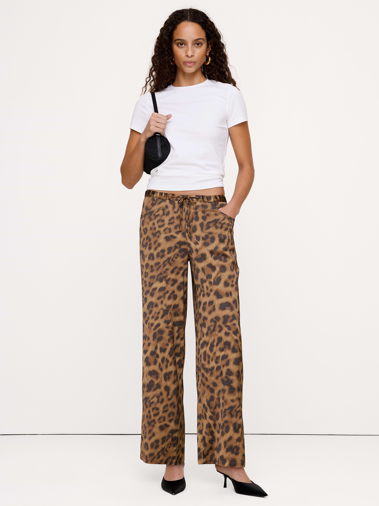 Image 1 of 8, Reach for these pants when you need to strike a balance between sharp tailoring and all-day comfort. We cut them from a stretch-satin fabric we love because it looks (and feels) fabulous on. Plus, we added elastic at the waist for a custom fit., Wide leg fit: Mid-rise with a straight fit through the thigh and wide leg. Full length., Concealed elastic waistband., Zip fly with button and drawstring closure., Front and back pockets., Unlined., Product #1180311