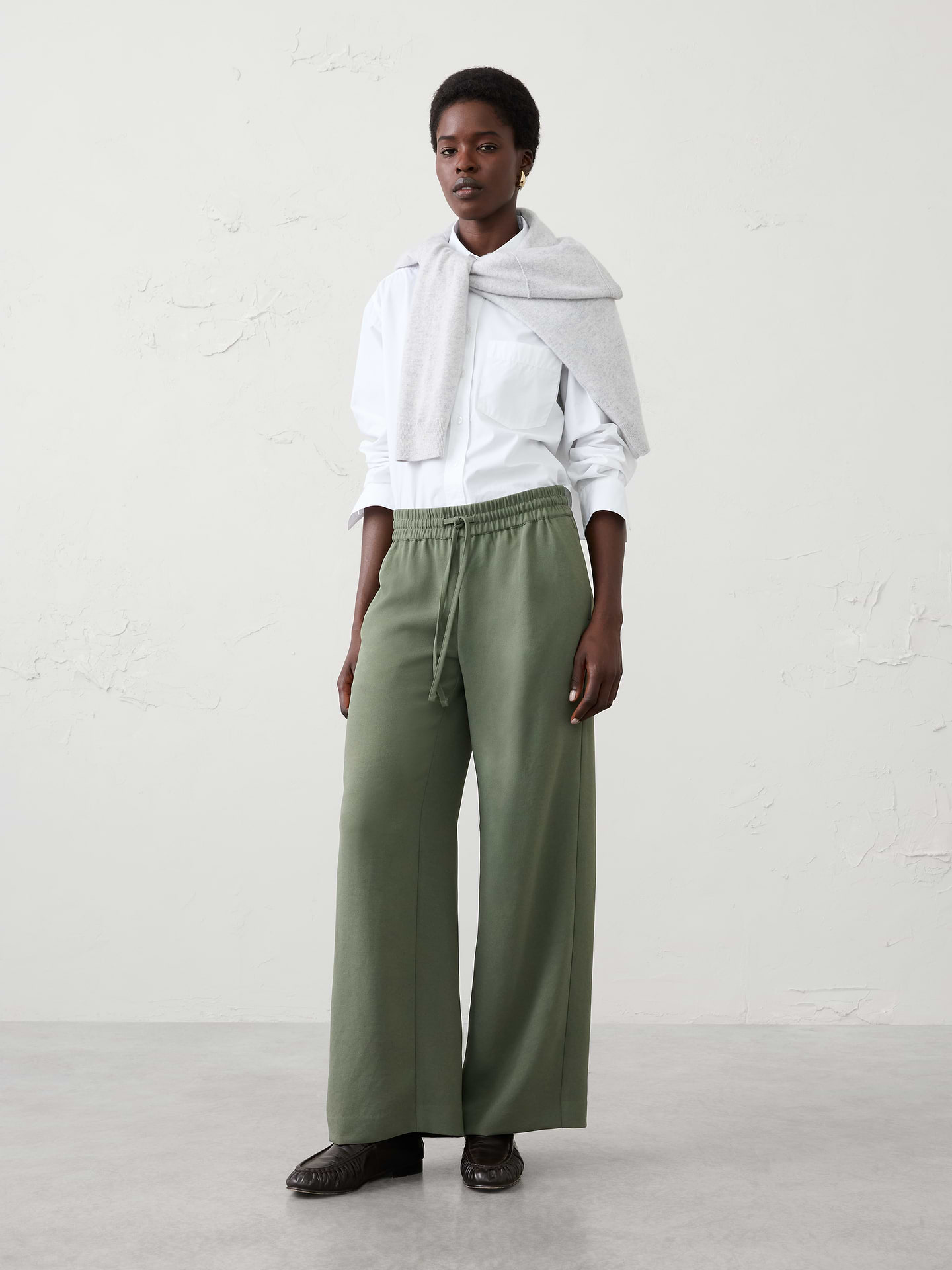 Image 1 of 5, The perfect blend of comfort and polish, this pull-on crepe pant is designed for effortless everyday versatility. Crafted from a fluid crepe fabric, it features a flattering mid-rise fit and a clean silhouette that transitions seamlessly from work to weekend. Whether dressed up with a blazer or styled casually with a knit top, this pant is a go-to staple for any occasion., SUSTAINABILITY: Made with 100% recycled polyester., Pull-on pant. Adjustable drawstring waistband., On-seam side pockets., Back welt pockets., Soft trouser crease., Made exclusively for Banana Republic Factory., Product #1182227
