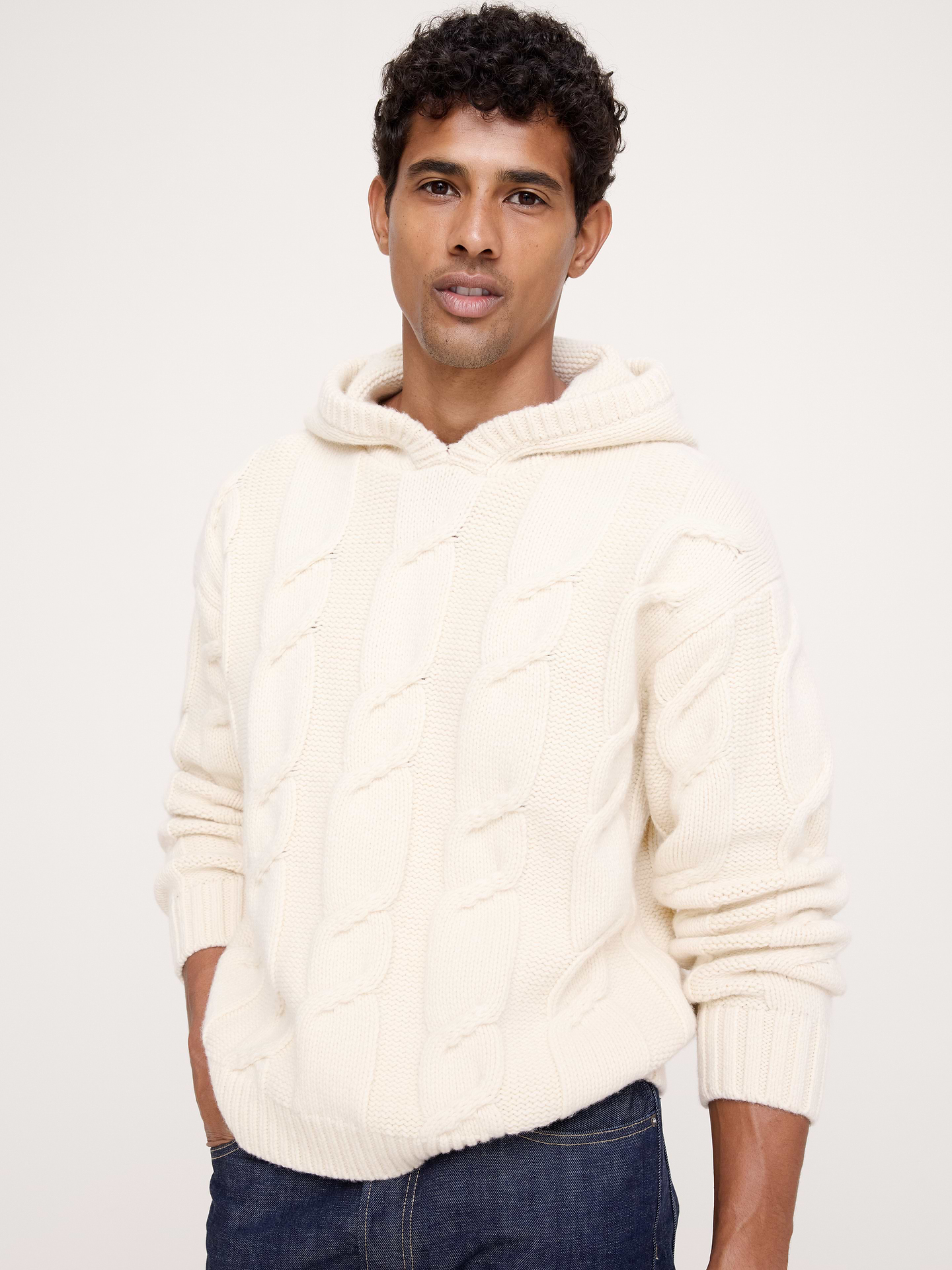 Image 1 of 5, We leaned into the classic cable hoodie, recreating it in a chunky wool blend so it's ideal for cold weather. We love the modern, après-ski vibe., Relaxed Fit: A straight & roomy fit. Dropped shoulder seam., Hooded., Front pocket., Straight hem., Product #907530