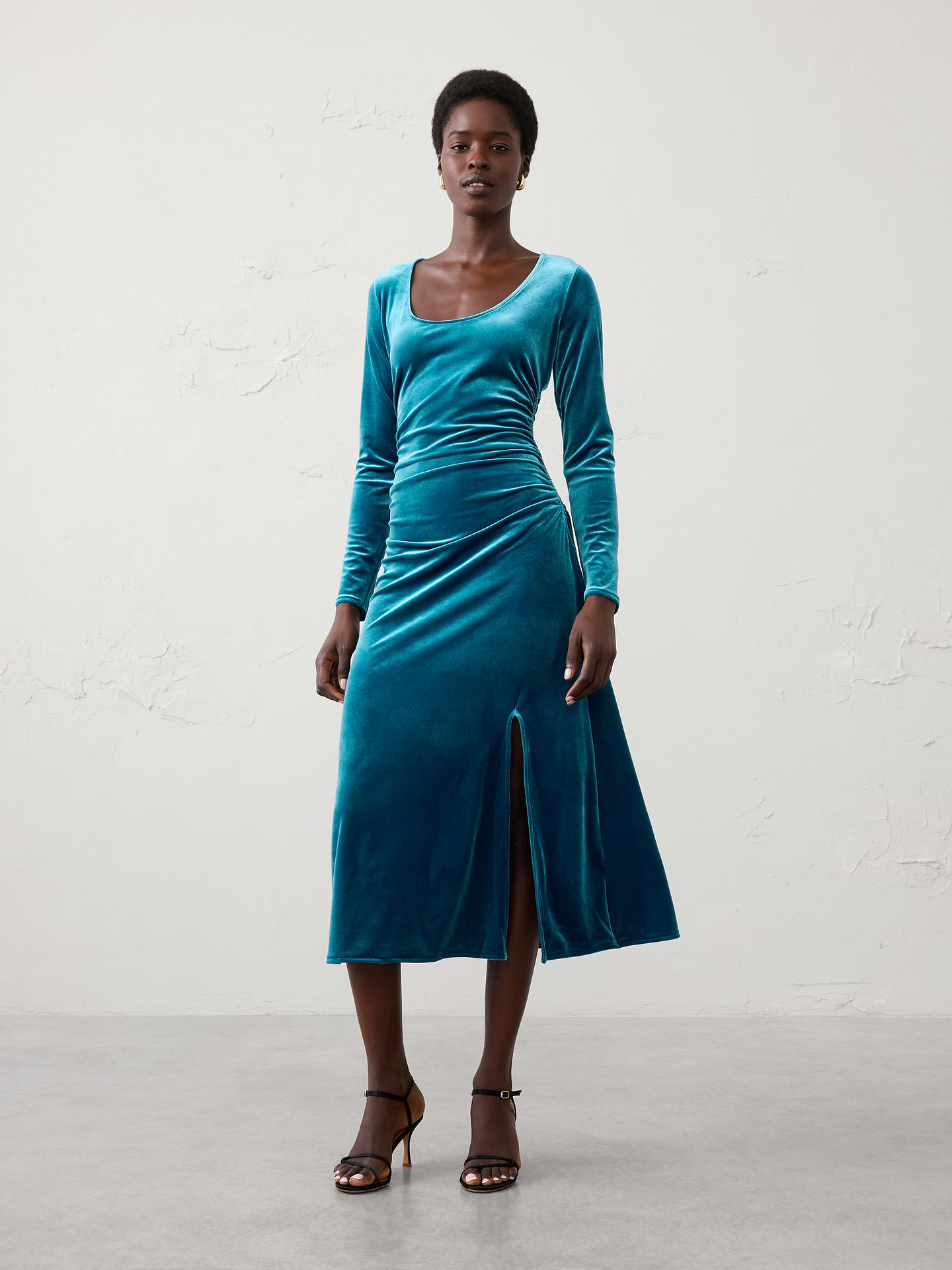 Image 1 of 4, Crafted from soft knit velvet with a subtle sheen, this sophisticated column silhouette is designed to flatter and move comfortably with you. Finished with a side slit for ease of movement and a touch of allure, this versatile dress is the perfect choice for holiday parties, dinners, and special occasions., Scoop neckline. Long sleeves., Side shirring at waist., Side slit detail., Made exclusively for Banana Republic Factory., Product #1185686