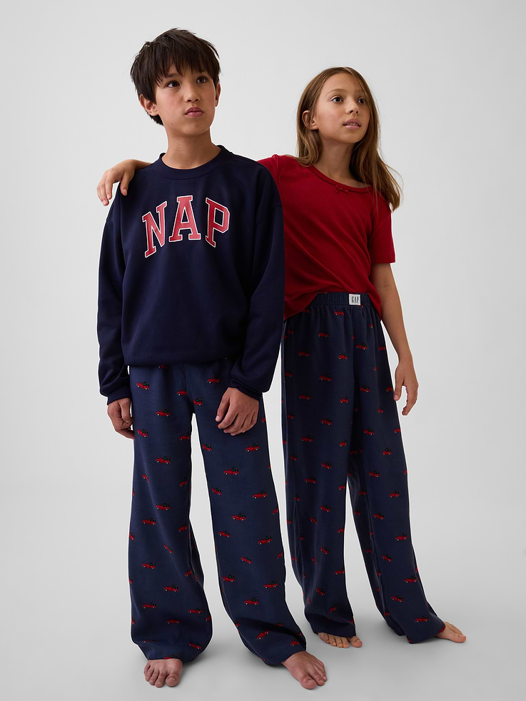 Image 1 of 3, Soft, brushed flannel pajama pants. In a loose fit., Elasticized waist with Gap label at front., Allover print., Made with 100% recycled polyester. Compared to virgin materials, using recycled materials helps reduce resource use and waste., Shop matching PJs for all., This product was made in a factory that invests in gender equity and women’s empowerment through RISE. Learn more at gapinc.com/equity ., Product #915781