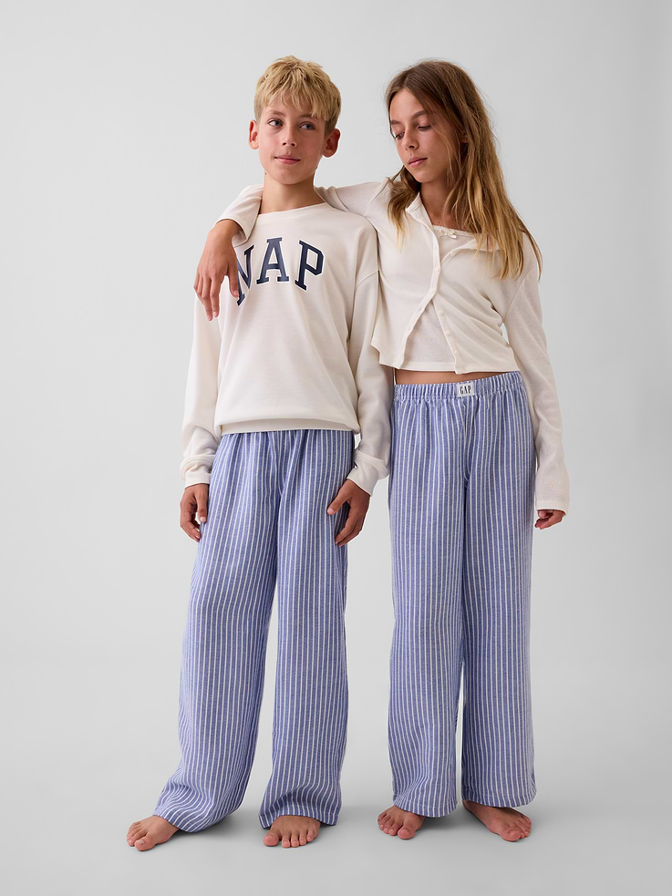 Image 1 of 6, Soft, brushed flannel pajama pants. In a loose fit., Elasticized waist with Gap label at front., Allover print., Made with 100% recycled polyester. Compared to virgin materials, using recycled materials helps reduce resource use and waste., Shop matching PJs for all., This product was made in a factory that invests in gender equity and women’s empowerment through RISE. Learn more at gapinc.com/equity ., Product #915781