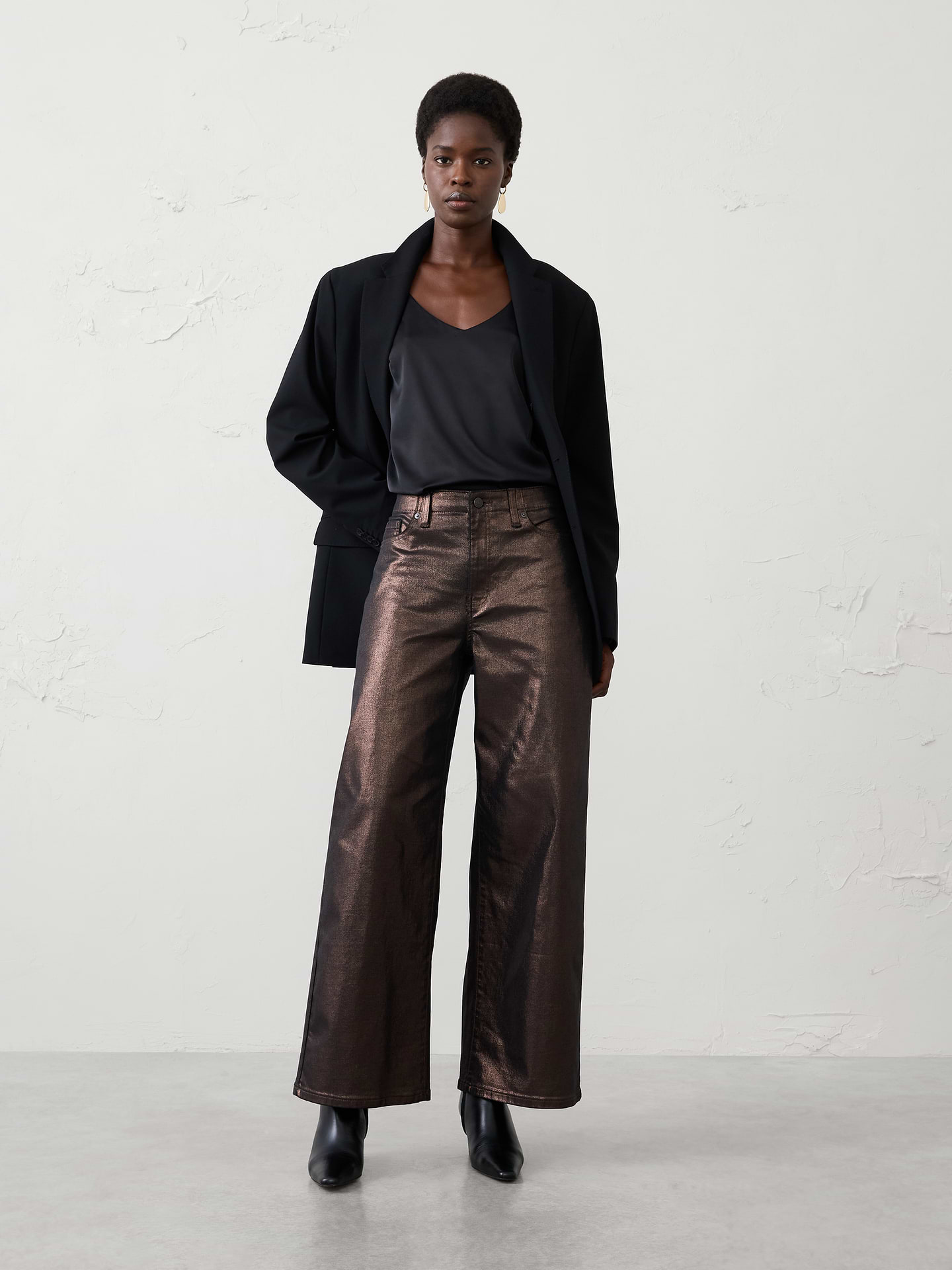 Image 1 of 4, Shine from day to night in this wide-leg high-rise metallic pant, crafted from coated metallic denim for a modern, elevated look., Fitted. High rise. Wide leg. Full length., Shank button closure with zip fly. Belt loops., Traditional five-pocket design., Designed with a Hollywood waistband for added ease and comfort., Made exclusively for Banana Republic Factory., Product #1181449