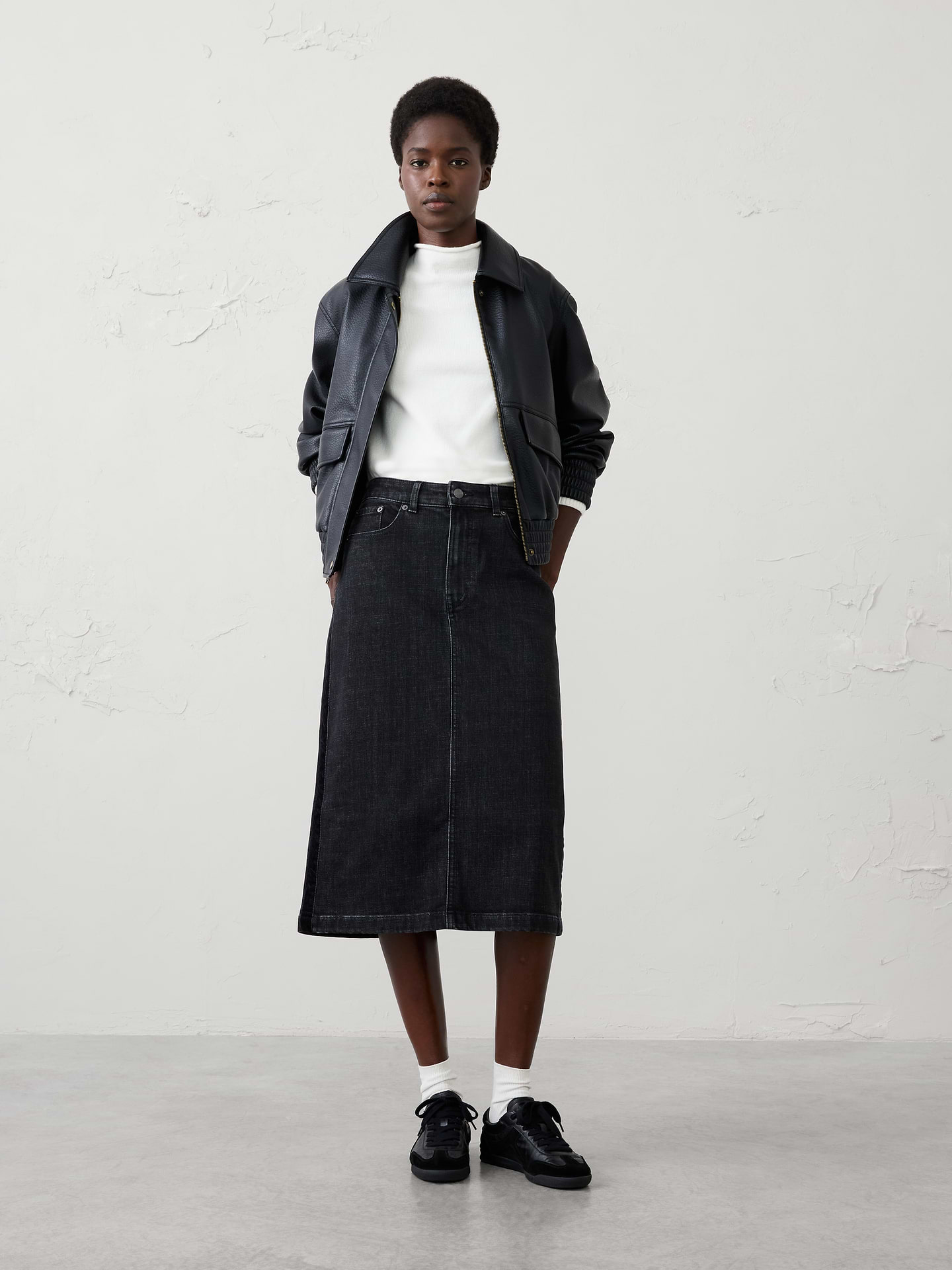Image 1 of 4, Elevate a wardrobe essential with this denim velvet-trim midi skirt. Designed in a flattering pencil silhouette, this versatile style combines classic denim construction with refined velvet trim detailing along the sides for a sophisticated twist. Perfect for pairing with sweaters, blouses, and boots, this skirt effortlessly transitions from casual days to elevated evenings., Shank button closure with zip fly. Belt loops., Traditional five-pocket design., Soft velvet trim along the sides adds a refined touch., Back center vent., Made exclusively for Banana Republic Factory., Product #1185770