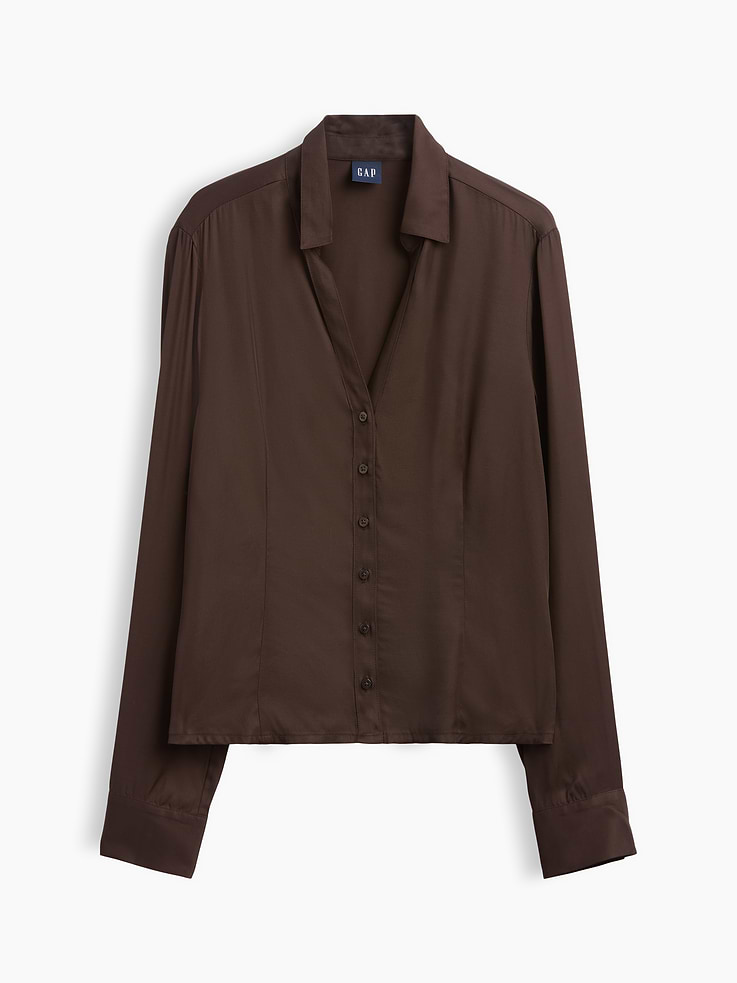 Image 1 of 2, Smooth rayon satin fitted shirt. In a slightly cropped length., Spread collar, v-neck., Long sleeves with button cuffs., Button front., Princess darts at front and back., This product was made in a factory that invests in gender equity and women’s empowerment through RISE. Learn more at gapinc.com/equity ., Product #1184283