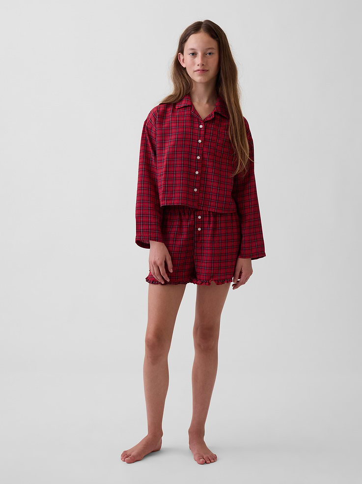 Image 1 of 4, Soft flannel pajama shirt and shorts PJ set., Notch collar, button front., Long sleeves with drop shoulders., Chest patch pocket., Elasticized waist with faux button fly at PJ shorts., Ruffle trim at hem., Allover plaid or Happy Stripe print., Made with 100% recycled polyester. Compared to virgin materials, using recycled materials helps reduce resource use and waste., Shop matching PJs for all., This product was made in a factory that invests in gender equity and women’s empowerment through RISE. Learn more at gapinc.com/equity ., Product #915897