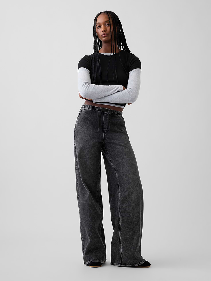 Image 1 of 2, Fit: A full-length knit denim baggy jean that's fitted on the waist & relaxed all the way down., Fabric: 78% Cotton, 21% Recycled Materials, 1% Stretch., Stretch: Low Stretch Jeans. Authentic denim with a soft & easy lived-in feel., Rise: Mid Rise Jeans., Look: A four-pocket, easy-on baggy jean in a black acid wash. , Details: Elasticized waist with drawcords, side slant pockets & back patch pockets., Responsibly Made: This pair of jeans is part of our water-saving Washwell program. Compared with conventional wash methods, Washwell uses at least 20% less water., Made with 51% Protocol cotton verified by the U.S. Cotton Trust Protocol, a program which works with farms committed to improving their environmental footprint by minimizing water usage and improving soil health (Claim No. 10127)., Made with 16% recycled polyester and 5% recycled cotton. Compared to virgin materials, using recycled materials helps reduce resource use and waste., This product was made in a factory that invests in gender equity and women’s empowerment through RISE. Learn more at gapinc.com/equity ., Product #1185264