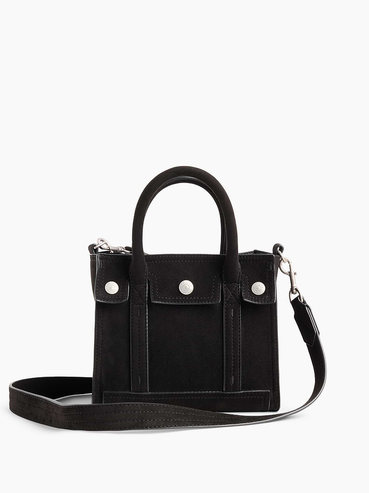 Image 1 of 7, Soft vegan suede tote bag. With vegan leather lining., Worn crossbody or handheld., Double handles and removable shoulder strap., Bridge snap closure at top., Button-snap pocket at front., Note: The dye used in the crafting of this product is prone to crocking, or color transfer. Please avoid contact with light-colored fabric or upholstery., Product #1189086