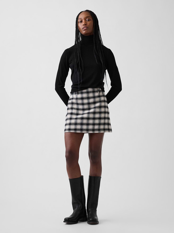 Image 1 of 5, Soft polyester-wool-blend mini skort. In an ultra mini length., Zipper with hook-and-eye closure at side seam., Belt loops., Allover plaid., Attached inner shorts., Skirt made with 69% recycled polyester. Compared to virgin materials, using recycled materials helps reduce resource use and waste., This product was made in a factory that invests in gender equity and women’s empowerment through RISE. Learn more at gapinc.com/equity ., Product #1185334