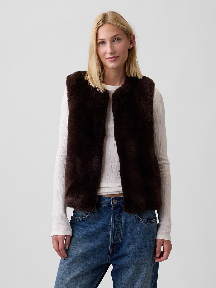 Image 1 of 5, This product is made with/contains 100% recycled polyester. Compared to virgin materials, using recycled materials helps reduce resource use and waste, Cozy faux fur., Sleeveless., Round neckline, zip front., This product was made in a factory that invests in gender equity and women’s empowerment through RISE. Learn more at, Product #1178412