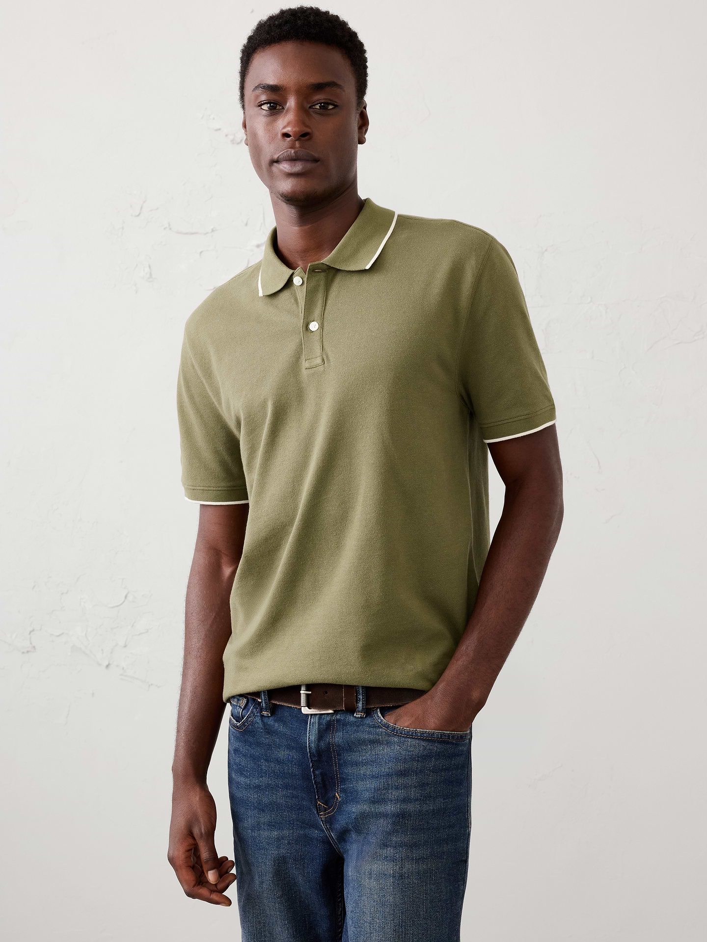 Image 1 of 4, Our pique polo with refined tipping detail offers an easy, versatile silhouette that moves effortlessly from workdays to weekends., Polo collar with button placket. Short sleeves., Welt chest pocket., Features contrasting tipped details., Straight hem with side slits., Made exclusively for Banana Republic Factory., Product #1182612