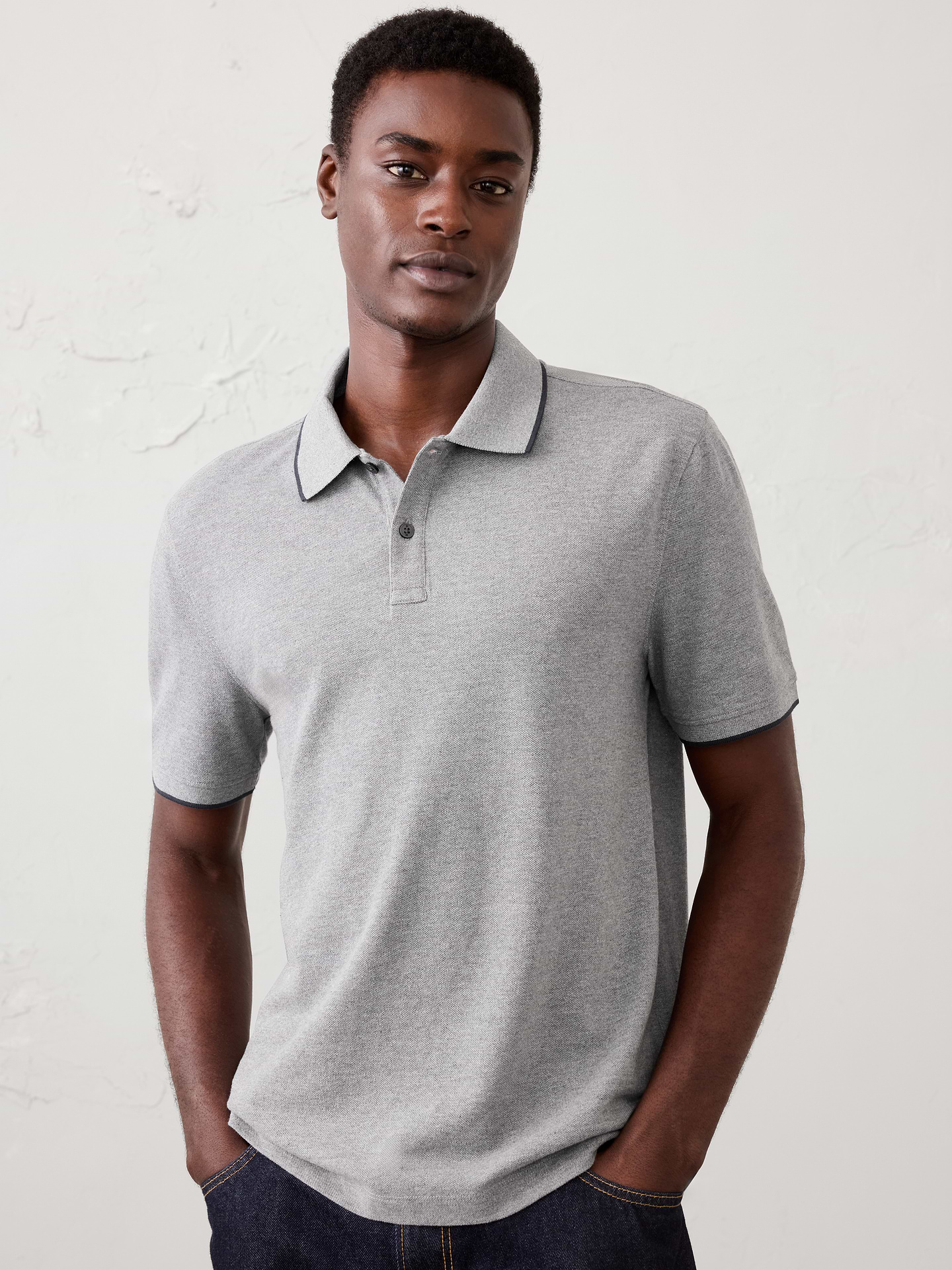 Image 1 of 4, Our pique polo with refined tipping detail offers an easy, versatile silhouette that moves effortlessly from workdays to weekends., Polo collar with button placket. Short sleeves., Welt chest pocket., Features contrasting tipped details., Straight hem with side slits., Made exclusively for Banana Republic Factory., Product #1182612