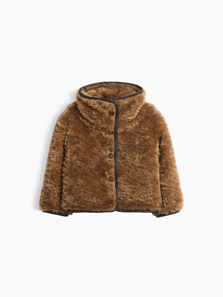 Image 1 of 5, Soft faux Sherpa jacket., Mockneck, button front., Long sleeves., Vegan leather binding at hem., Faux sherpa made with 100% recycled polyester. Compared to virgin materials, using recycled materials helps reduce resource use and waste., This product was made in a factory that invests in gender equity and women’s empowerment through RISE. Learn more at gapinc.com/equity ., Product #1185602