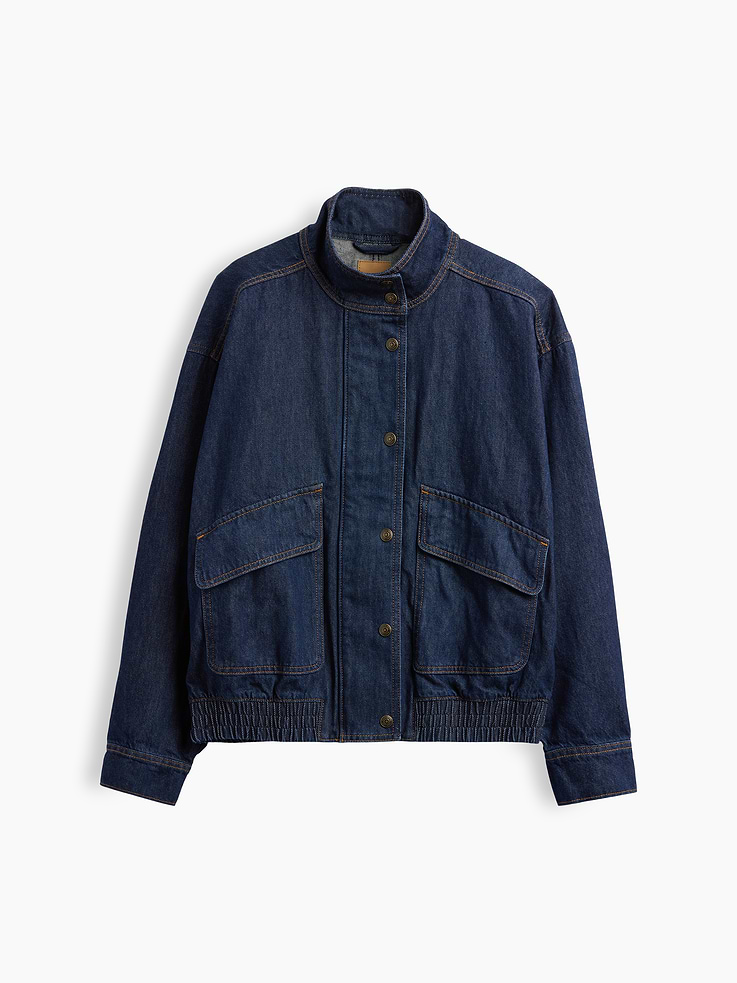 Image 1 of 2, Authentic, non-stretch denim bomber jacket. In an oversized fit., Mockneck., Long sleeves with drop shoulders and snap button cuffs., Concealed zipper front beneath full snap button placket., Vertical back seam., Front flap patch pockets., Elasticized hem., Responsibly Made: This denim jacket is part of our water-saving Washwell program. Compared with conventional wash methods, Washwell uses at least 20% less water., More Sustainable Cotton: Made with 5% recycled cotton. Compared to virgin materials, using recycled materials helps reduce resource use and waste., This product was made in a factory that invests in gender equity and women’s empowerment through RISE. Learn more at gapinc.com/equity ., Product #1186418