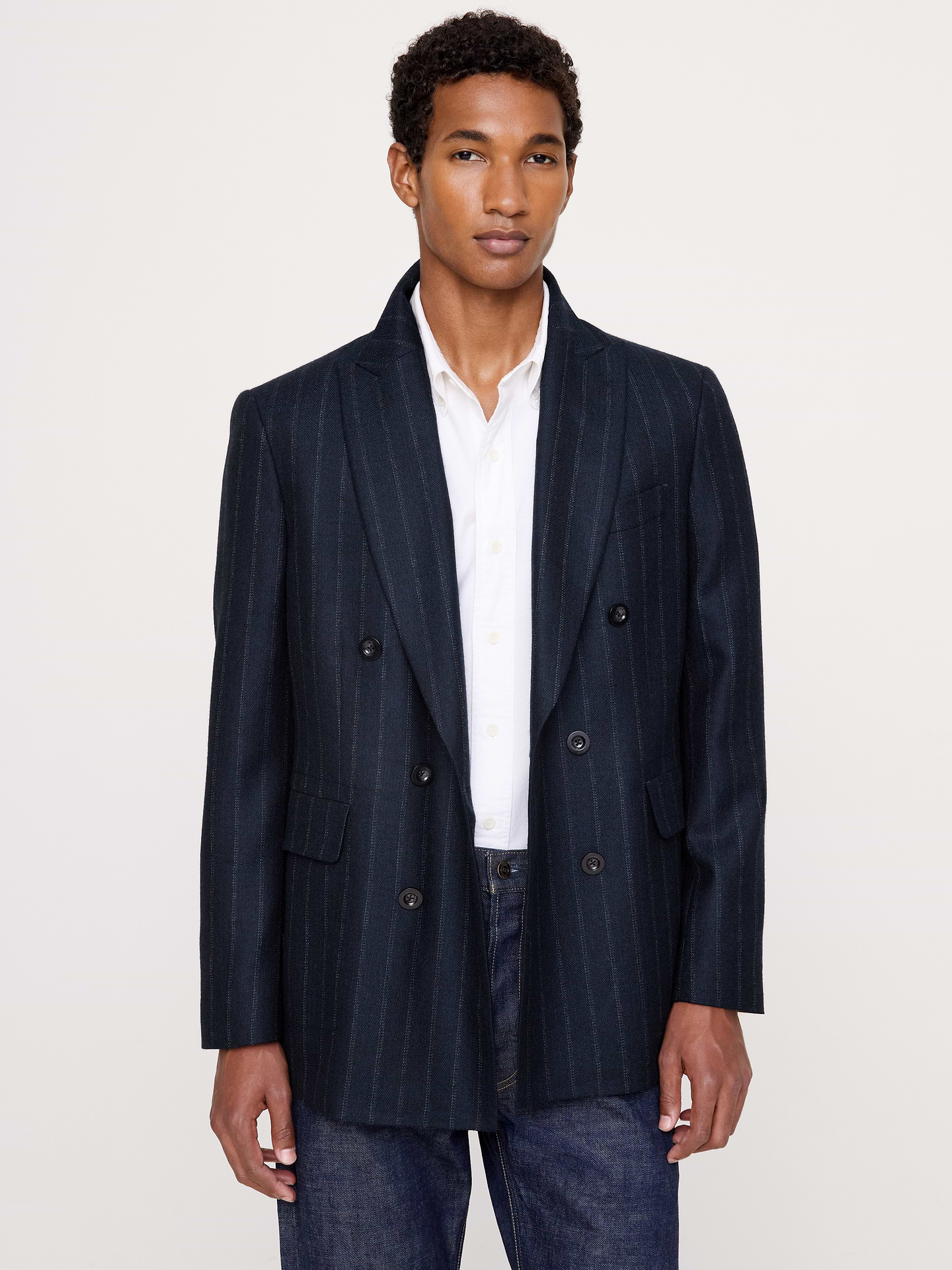 Image 1 of 7, Our expertly tailored sport coat is crafted from wool herringbone that's lightweight yet warm enough to carry you through cooler climes., Sport Coat Fit: We updated our Tailored Slim Fit for a more laidback and slightly less form-fitting silhouette for ultimate versatility., Peak lapel with double-breasted closure., Three exterior pockets. One interior pocket., Single back vent., Fully lined., Product #906698