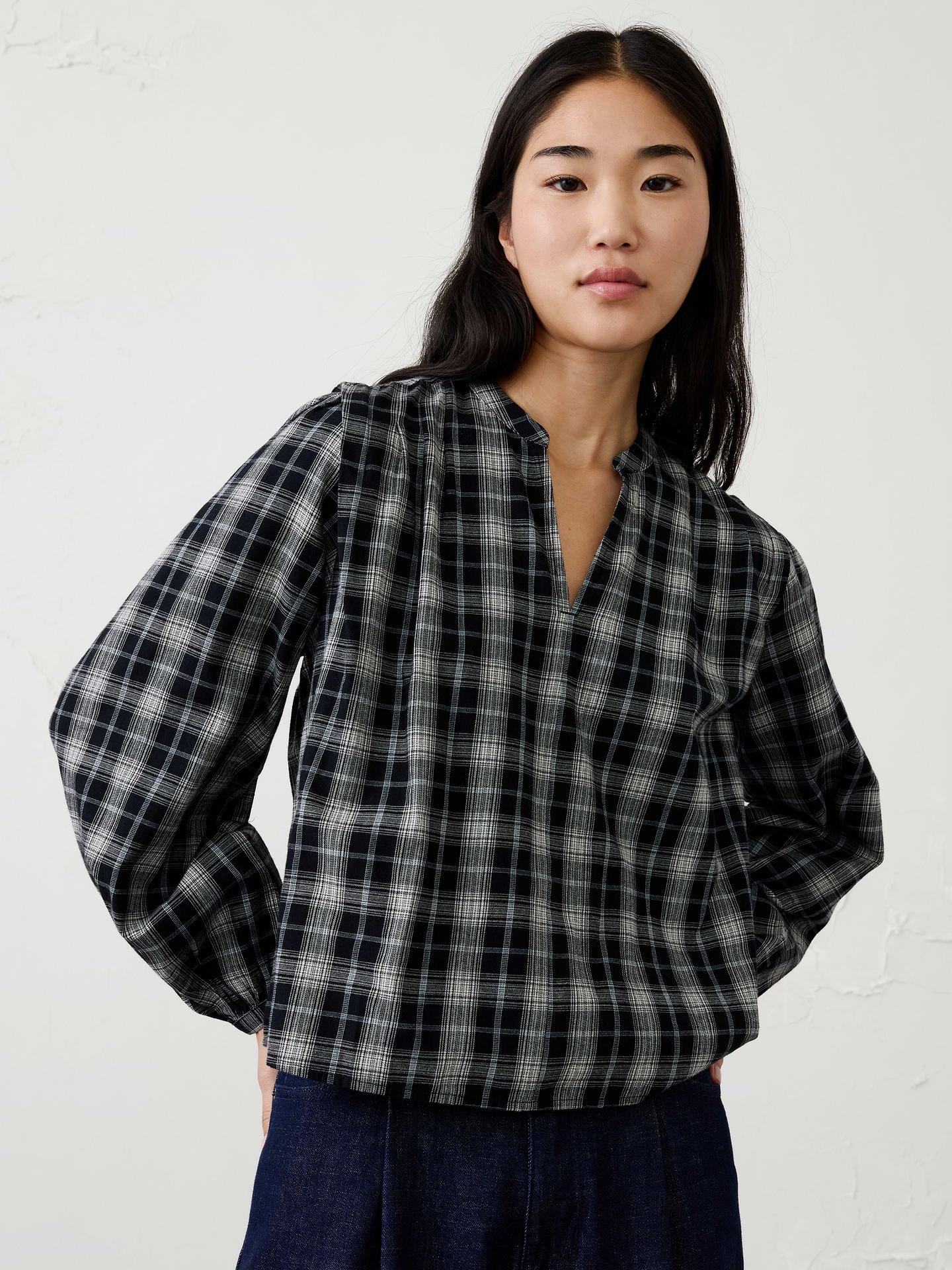 Image 1 of 4, Crafted in a soft plaid flannel, our blouse features feminine pleated‑shoulder detailing for an elevated touch. Cozy yet polished, it brings warmth, texture, and effortless style to holiday gatherings and seasonal everyday dressing., Band collar with split V-neck opening. Long blouson sleeves with buttoned cuffs., Pleated shoulder detailing., Back yoke with center pleated detailing., Made exclusively for Banana Republic Factory., Product #1185897