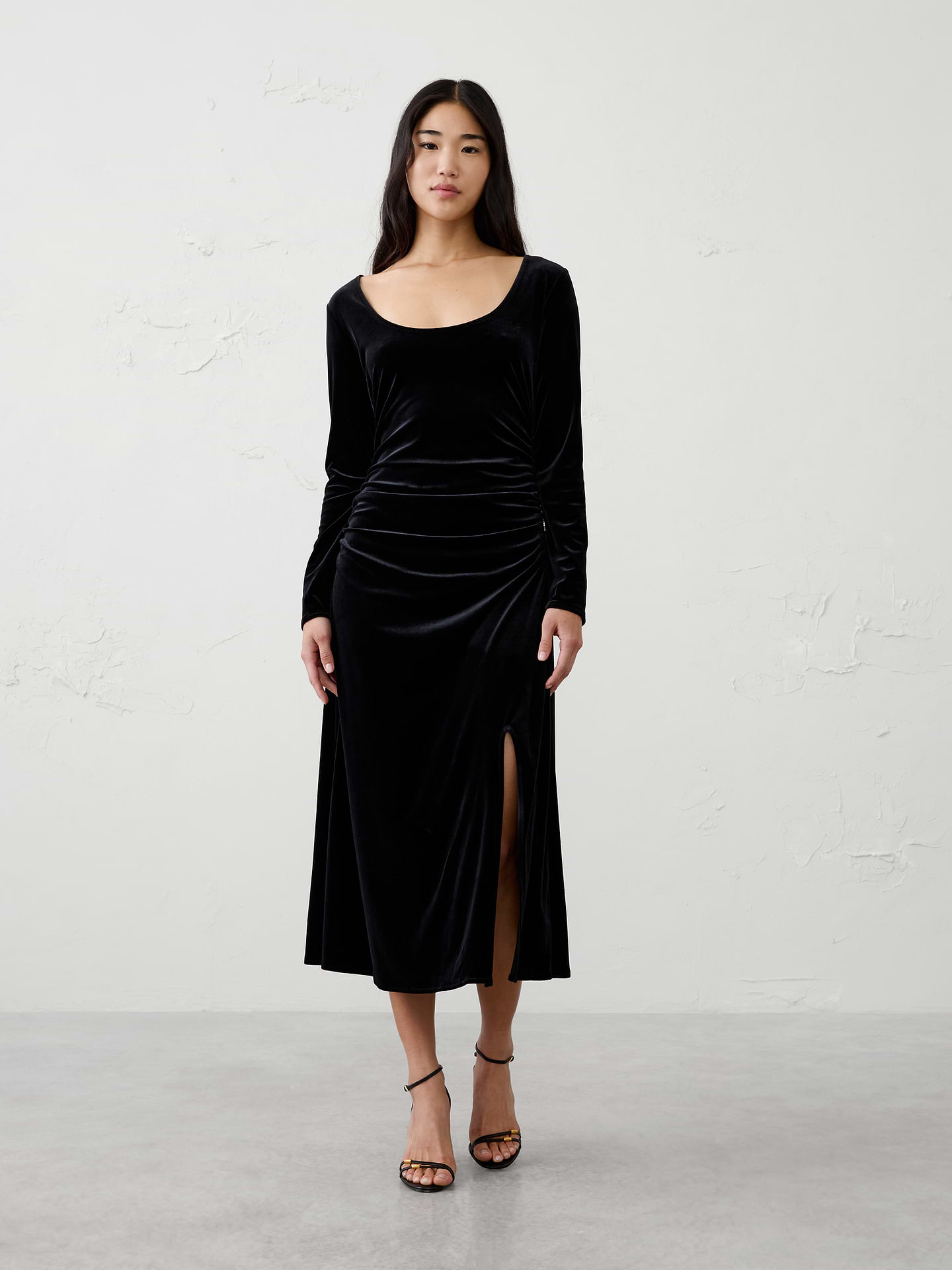 Image 1 of 4, Crafted from soft knit velvet with a subtle sheen, this sophisticated column silhouette is designed to flatter and move comfortably with you. Finished with a side slit for ease of movement and a touch of allure, this versatile dress is the perfect choice for holiday parties, dinners, and special occasions., Scoop neckline. Long sleeves., Side shirring at waist., Side slit detail., Made exclusively for Banana Republic Factory., Product #1185686