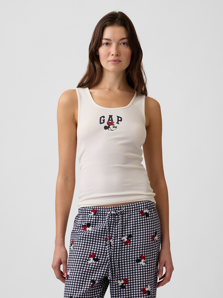 Image 1 of 5, A very special collaboration between Gap and Disney— two timeless, iconic American brands— led us to create a collection that celebrates Mickey Mouse and Minnie Mouse., Soft ribbed sleep tank., Tank straps., Scoopneck., Gap logo with Minnie Mouse graphic at front., This product was made in a factory that invests in gender equity and women’s empowerment through RISE. Learn more at, Product #1187667