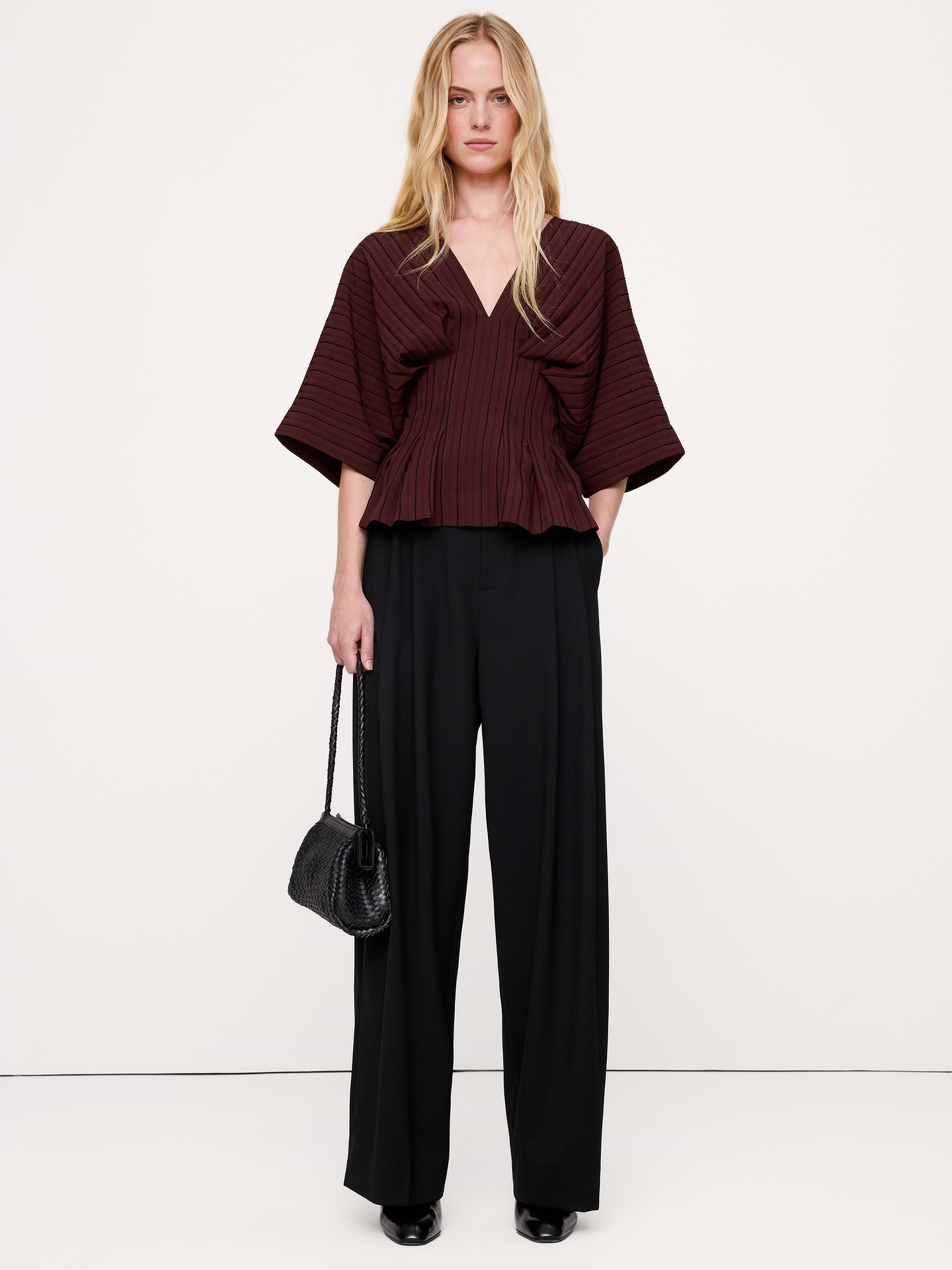 Image 1 of 7, A playful take on a peplum top, this one uses an array of artful pleats to create an hourglass silhouette in a smooth viscose blend., Fit & Flare: Relaxed through shoulders and chest, defined waist., V-neck. V-back., Invisible zip at back., Straight hem., Product #1190104