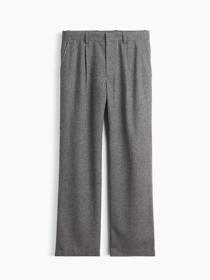 Image 1 of 2, Soft wool-blend trouser pants. In a loose fit., Hidden hook-and-bar closure, zip fly., Pleated front., Side slant pockets, back welt pockets., Made with 50% recycled polyester. Compared to virgin materials, using recycled materials helps reduce resource use and waste., This product was made in a factory that invests in gender equity and women’s empowerment through RISE. Learn more at gapinc.com/equity ., Product #1184867