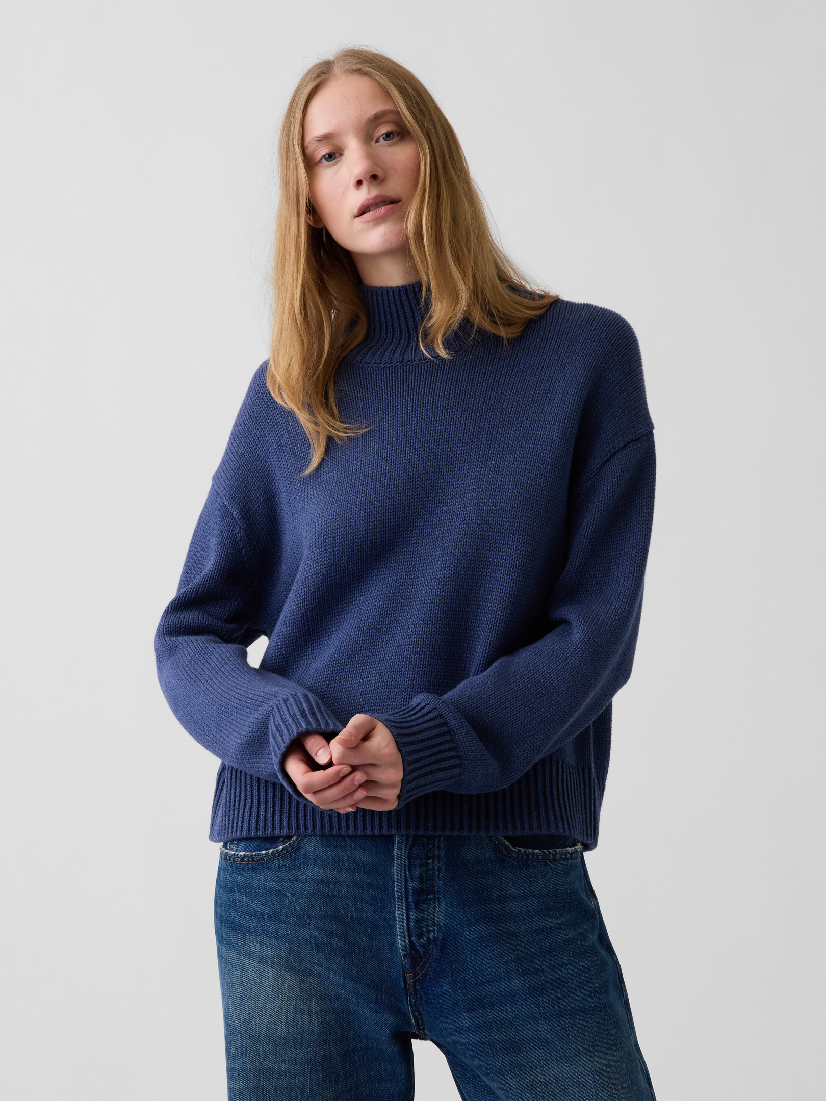 Image 1 of 5, Soft knit cotton sweater. In an oversized fit and slightly cropped length., Mockneck., Long sleeves with drop shoulders., Ribbed cuffs and hem., This product was made in a factory that invests in gender equity and women’s empowerment through RISE. Learn more at gapinc.com/equity ., Product #1186084