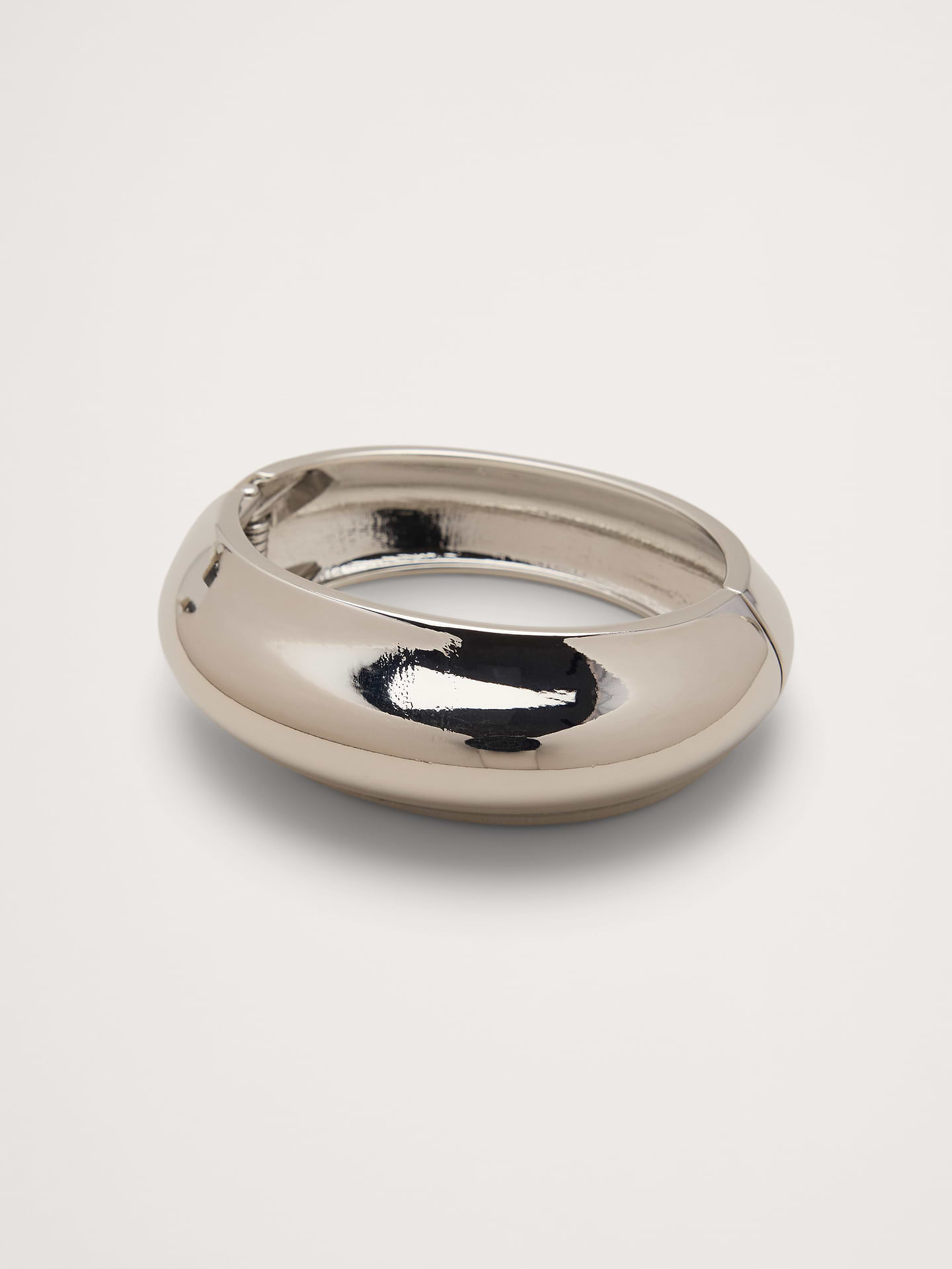 Image 1 of 2, An easy and elegant hinge-style bangle bracelet made from silver-toned metal alloy., Ben‑Amun: New York–crafted statement jewelry known for bold silhouettes, rich finishes, and couture‑level craftsmanship inspired by art, fashion, and history., Hinge closure., Product #1200081