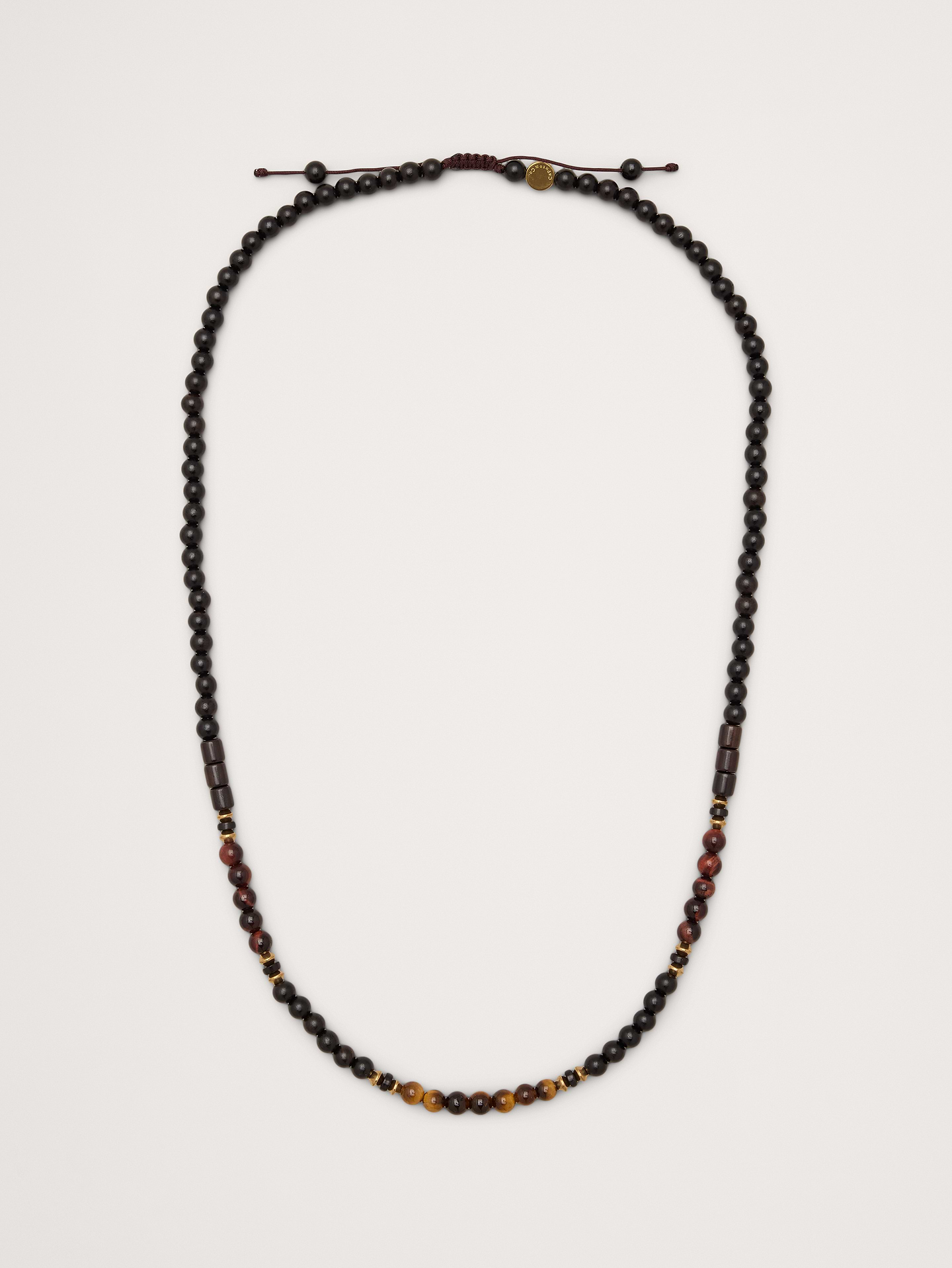 Image 1 of 3, An adjustable necklace with wooden beads accented with malachite, green African jasper, and brass spacers., Caputo & Co: Modern artisanal accessories that marries American soul with Central American heart. Handcrafted sterling silver, premium gemstones, and quality leathers., Adjustable pull-cord closure., Product #1200076