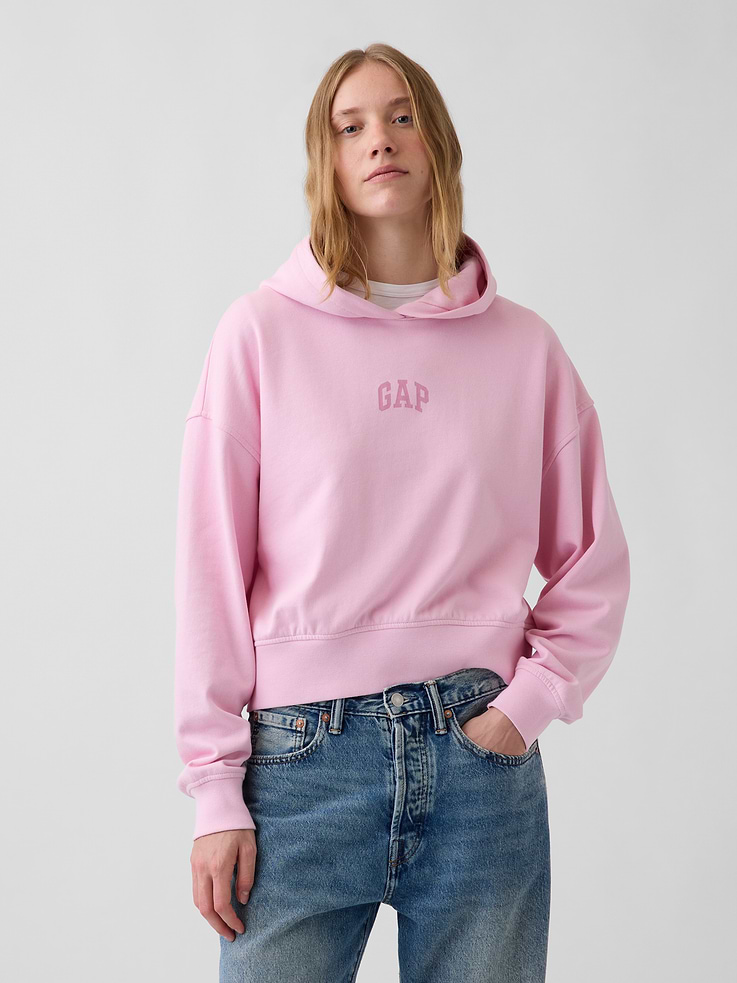 Image 1 of 6, Soft cotton-blend French terry hoodie. In an oversized, slightly cropped fit., Hooded neckline., Long sleeves with drop shoulders., Gap arch logo at front and back., Banded rib hem and cuffs., This product was made in a factory that invests in gender equity and women’s empowerment through RISE. Learn more at gapinc.com/equity ., Product #1196048