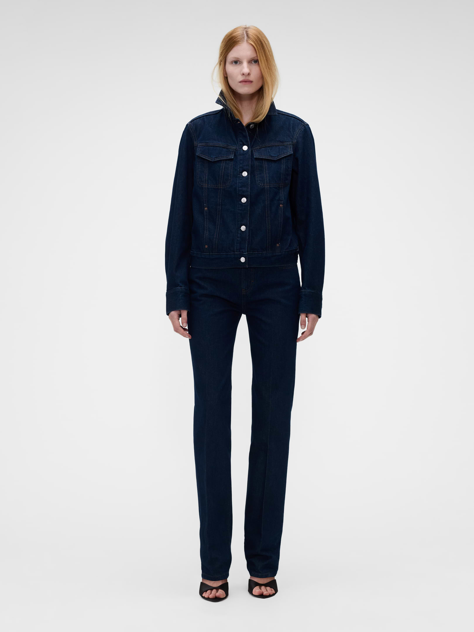 Image 1 of 9, Fit: A full-length straight jean that’s fitted through the hip and thigh., Fabric: 95% Cotton, 5% Recycled Cotton., No Stretch: Rigid Jeans. Authentic denim that gets better with every wear. Made to wear all day & break in over time. , Rise: High Rise Jeans., Inseam: 31” longer inseam., Look: A classic straight jean designed to stack with flats or hit below the ankle in heels., Details: Zip fly, five-pocket styling, red stitching, rinse wash, & Gap × Victoria Beckham logo leather patch at back., Responsibly Made: This jean is part of our water-saving Washwell program. Compared with conventional wash methods, Washwell uses at least 20% less water., More Sustainable Cotton: Made with 5% recycled cotton. Compared to virgin materials, using recycled materials helps reduce resource use and waste., Product #1183583