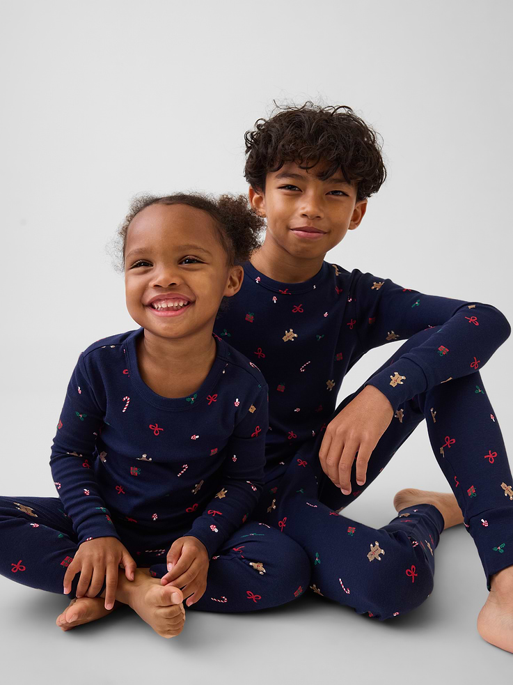 Image 1 of 6, Our comfiest PJs—now softer than ever. Cozy brushed cotton on the inside. All their favorite prints & colors on the outside., Soft cotton pajama top and pants PJ set with a cozy brushed interior., Crewneck., Long sleeves., Elasticized waist at PJ pants., Banded cuffs., Allover print., Made with 100% organically grown cotton, which is grown without the use of synthetic pesticides and fertilizers., Note: Sizing for select prints extends up to 12 YRS for certain styles., Shop matching PJs for all., This product was made in a factory that invests in gender equity and women’s empowerment through RISE. Learn more at gapinc.com/equity ., Product #915908