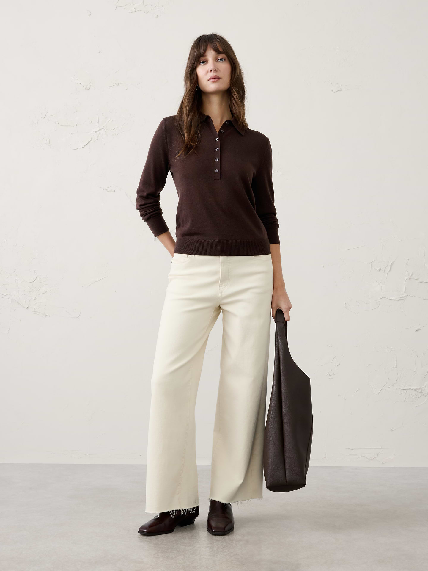 Image 1 of 3, Crafted from luxuriously soft Merino wool, this sweater offers lightweight warmth and natural breathability for all‑day comfort. Perfect for layering or wearing on its own, it delivers timeless versatility with an effortlessly refined finish., Polo collar. Long sleeves., Button placket., Ribbed arm cuffs and hem., Made exclusively for Banana Republic Factory., Product #1177059