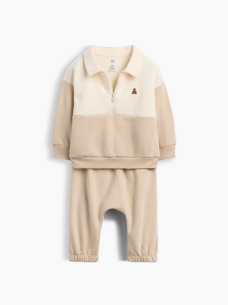 Image 1 of 2, Our softer than soft sweats. Brushed on the inside. Smooth on the outside. Made so that no two are alike., Soft cotton-blend fleece sweatshirt and sweatpants outfit set., Spread polo collar with quarter-zip closure., Long sleeves with drop shoulders., Embroidered Brannan Bear at chest., Colorblock design., Banded rib cuffs and hem., Elasticized waist and cuffs at pants., Made with 52% Protocol cotton verified by the U.S. Cotton Trust Protocol, a program which works with farms committed to improving their environmental footprint by minimizing water usage and improving soil health (Claim No. 10127)., Made with 23% recycled polyester. Compared to virgin materials, using recycled materials helps reduce resource use and waste., Explore our babyGap Guide ., This product was made in a factory that invests in gender equity and women’s empowerment through RISE. Learn more at gapinc.com/equity ., Product #1181393