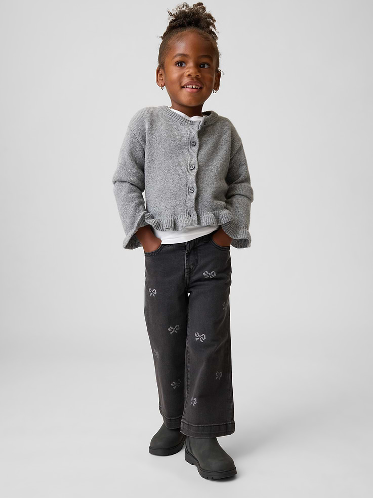 Image 1 of 4, Low-stretch denim jeans., Snap closure (sizes 2T-5T have hook & bar closure and zip fly)., Classic five-pocket styling., Black wash., Allover sparkle bows., This pair of jeans is part of our water-saving Washwell program. Compared with conventional wash methods, Washwell uses at least 20% less water., Made with 5% recycled cotton. Compared to virgin materials, using recycled materials helps reduce resource use and waste., This product was made in a factory that invests in gender equity and women’s empowerment through RISE. Learn more at gapinc.com/equity ., Product #1185640