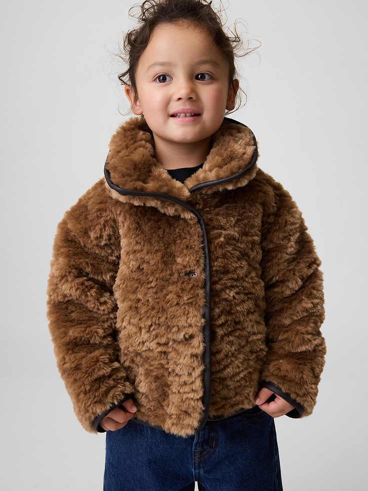 Image 1 of 5, Soft faux Sherpa jacket., Mockneck, button front., Long sleeves., Vegan leather binding at hem., Faux sherpa made with 100% recycled polyester. Compared to virgin materials, using recycled materials helps reduce resource use and waste., Explore the Gap Gift Shop ., This product was made in a factory that invests in gender equity and women’s empowerment through RISE. Learn more at gapinc.com/equity ., Product #1185602