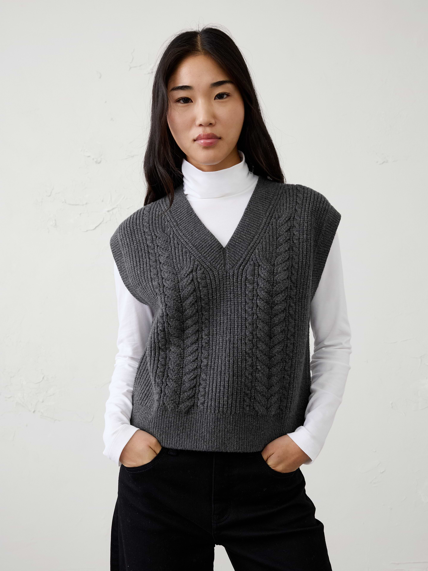 Image 1 of 4, Our sweater is knit from our signature Perfectly Soft yarn—a luxurious blend of cotton with a hint of wool, that feels as cozy as it looks. Classic cable stitching adds timeless texture and dimension, elevating the clean silhouette with a heritage‑inspired touch., V-neckline. Cap sleeves., Ribbed neck, arm cuffs and hem., Made exclusively for Banana Republic Factory., Product #1177098