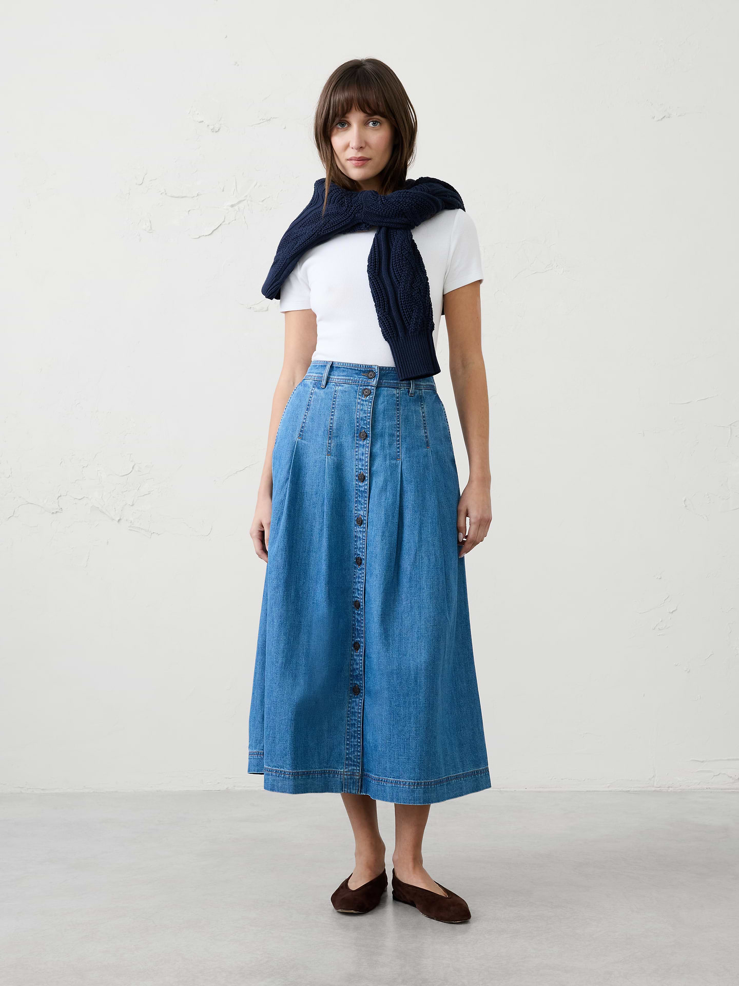 Image 1 of 4, An effortless staple you'll reach for again and again, this denim button-front midi skirt combines timeless style with everyday versatility., Full button-front closure. Belt loops., Front and back pleat detailing., Side front pockets., Made exclusively for Banana Republic Factory., Product #1185774