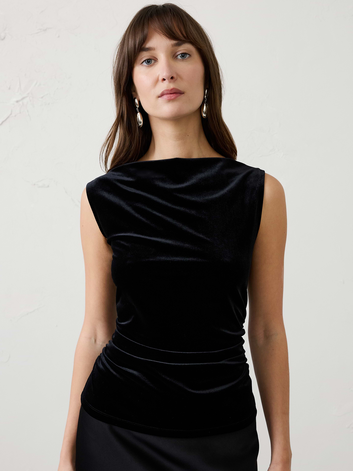 Image 1 of 4, Made from our ultra‑soft knit velvet, this top combines luxurious texture with effortless comfort. Side ruching creates a flattering, shape‑enhancing fit, while the rich velvet finish makes it the perfect piece to elevate your festive wardrobe., Straight neckline. Sleeveless., Side shirring at waist., Fitted at the waist., Made exclusively for Banana Republic Factory., Product #1186014