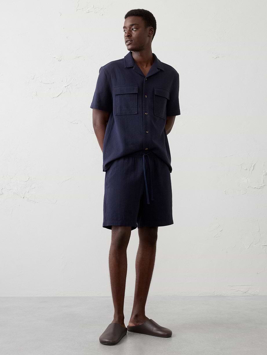 Man in navy shirt and navy shorts.